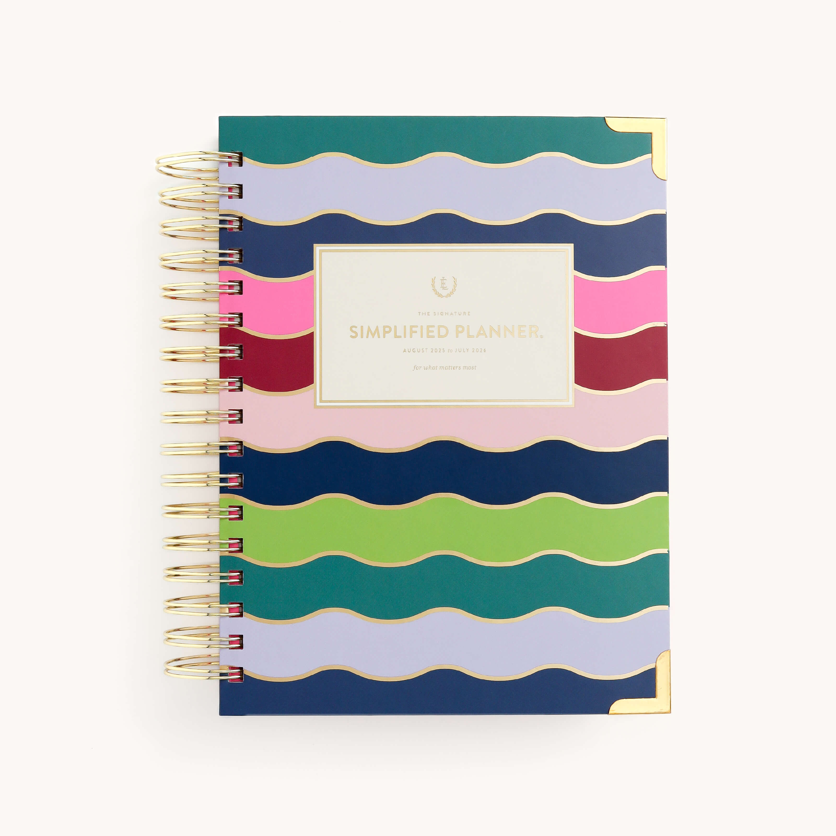 A vibrant spiral-bound planner with wavy stripes in blue, green, pink, and purple enhanced by gold foil. The central label reads 2025-2026 Spiral Daily Simplified Planner - Rainbow Row, ideal for organizing your Simplified Prep Work.