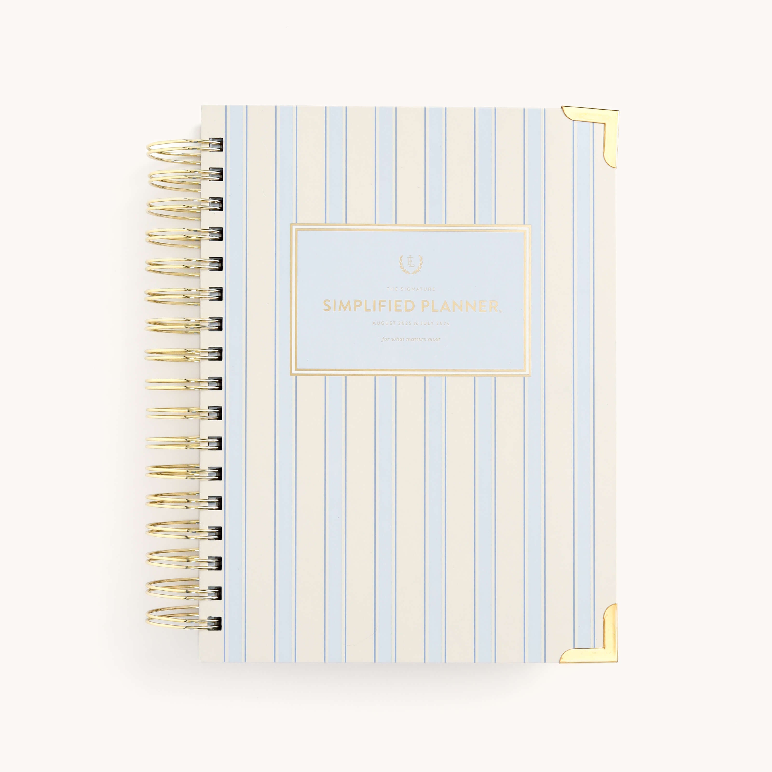 The 2025-2026 Spiral Daily Simplified Planner by Simplified features a white and blue striped cover with elegant gold foil corner details. Its gold spiral binding complements the design, and a centered label reads Simplified Planner, ensuring stylish daily organization.