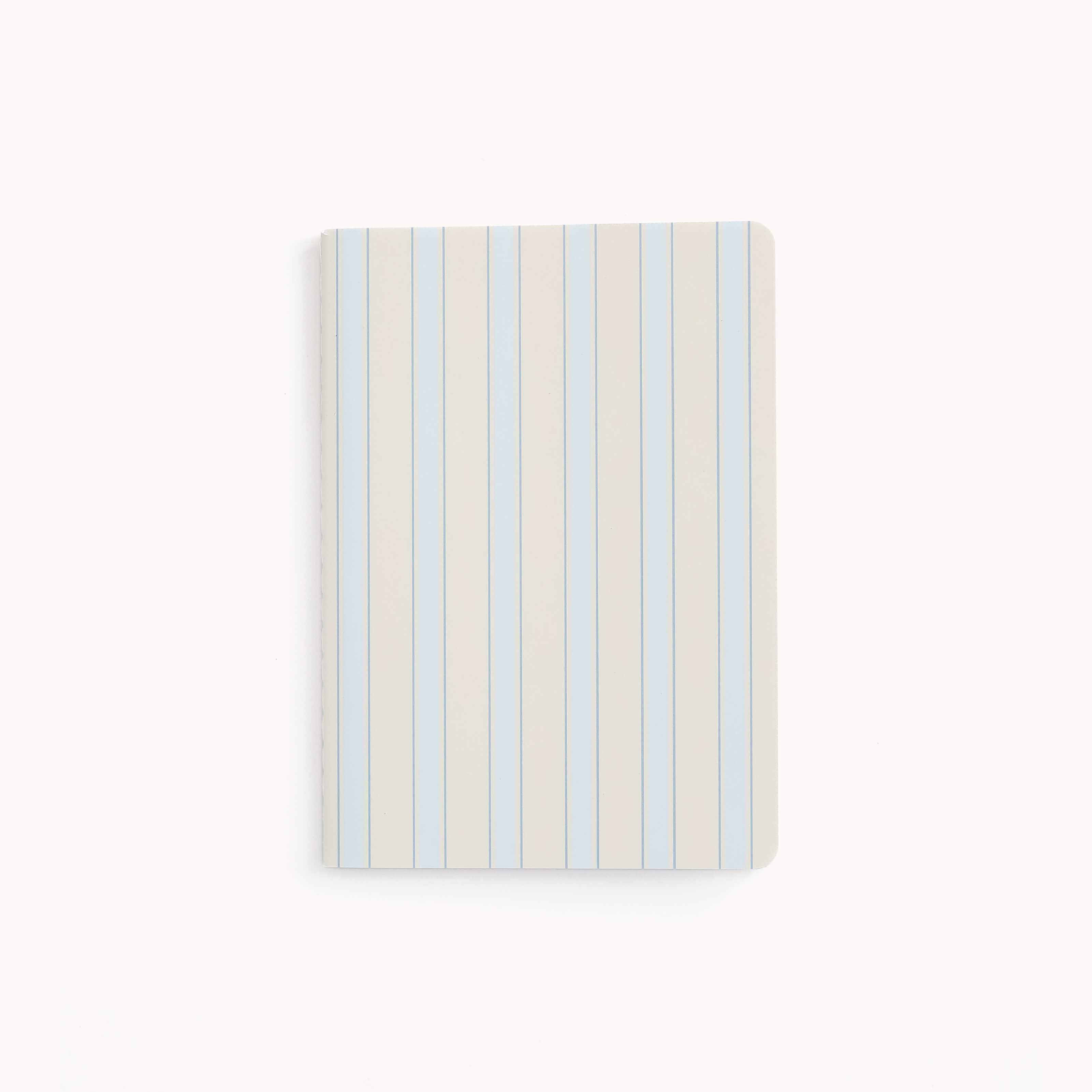 The Mini Notebook - Serene Stripe by Simplified features a thick paper cover with vertical blue and white stripes on a white background, complete with rounded corners for enhanced style and durability.