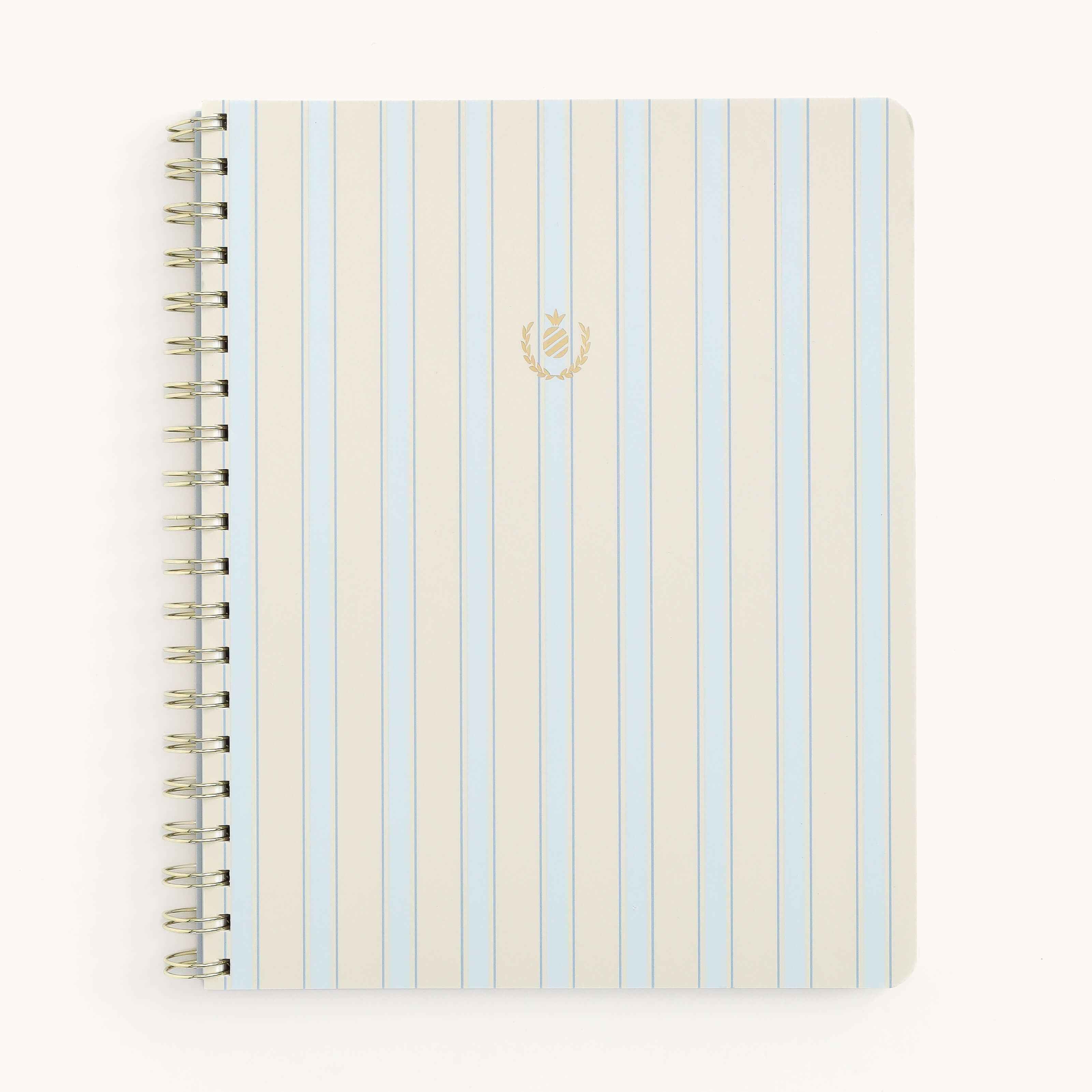 The Simplified Notebook - Serene Stripe features a soft-touch cover with vertical blue and white stripes, a small gold emblem at the center, and elegant gold wire-o binding, complemented by a plain white background.