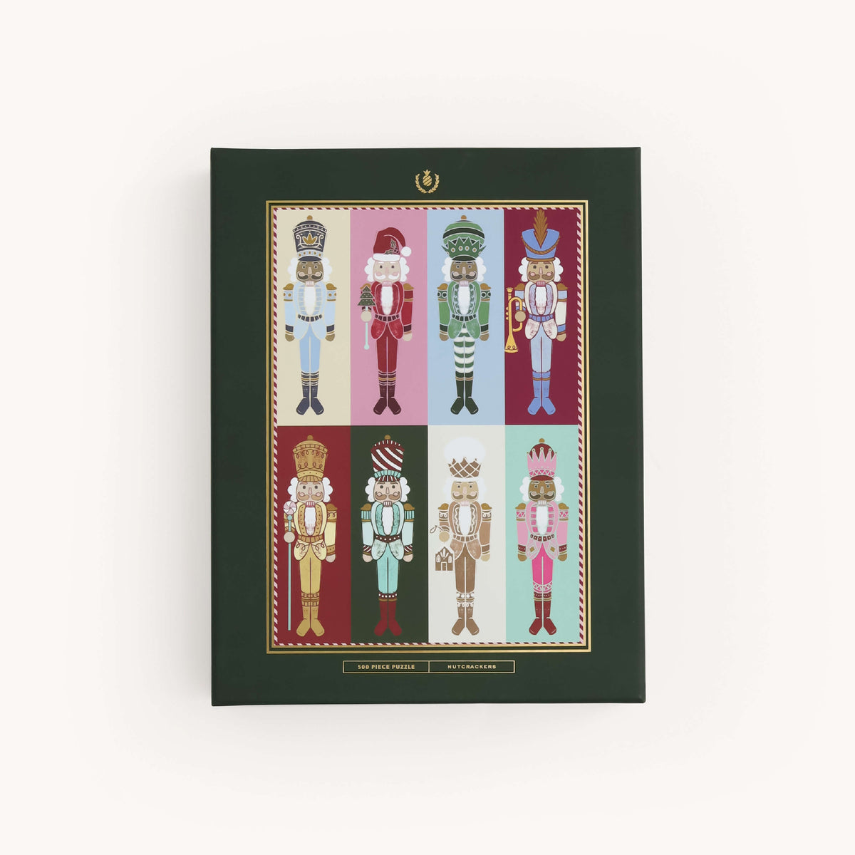 Nutcrackers 500-Piece Jigsaw Puzzle box in dark green with gold foil, showing eight colorful hand-drawn nutcrackers