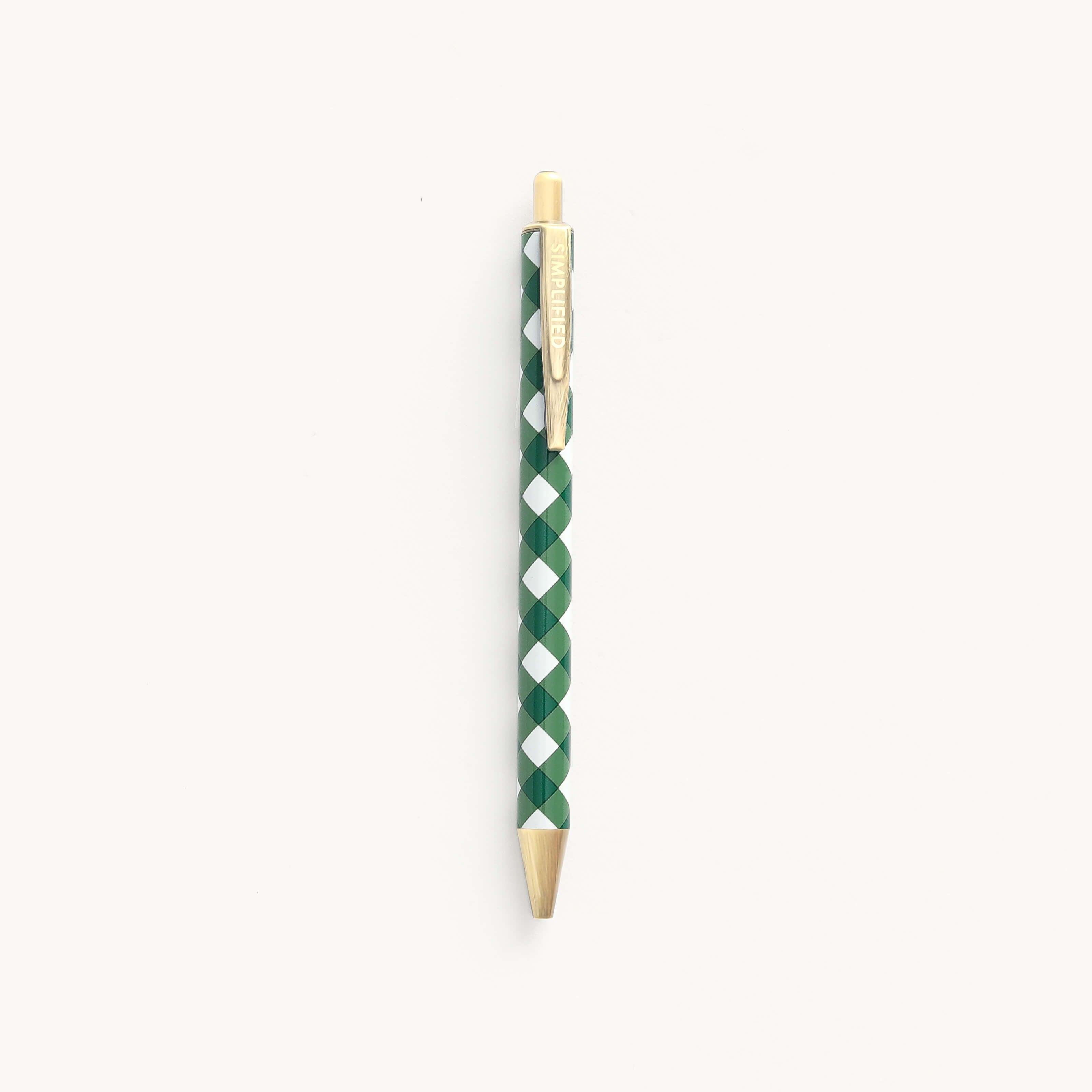 A green and white checkered Click Pen - Camp Gingham by Simplified, featuring a gold clip and tip with an elegant metal body, is vertically centered on a plain white background. The text on the clip is faintly visible.