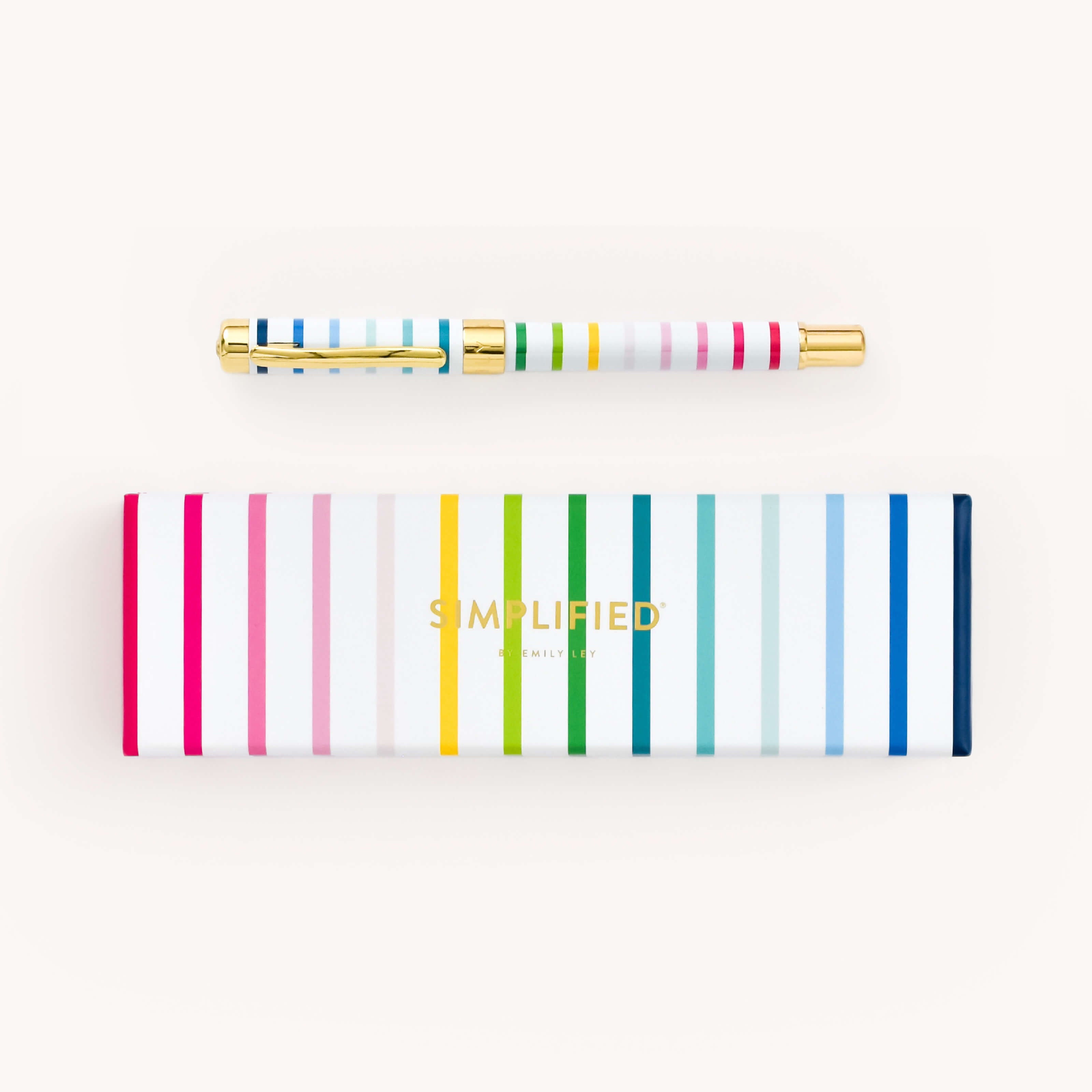 Simplified by Emily Ley | Gold metal pen in Happy Stripe design, featuring a gold clip and embellishments.