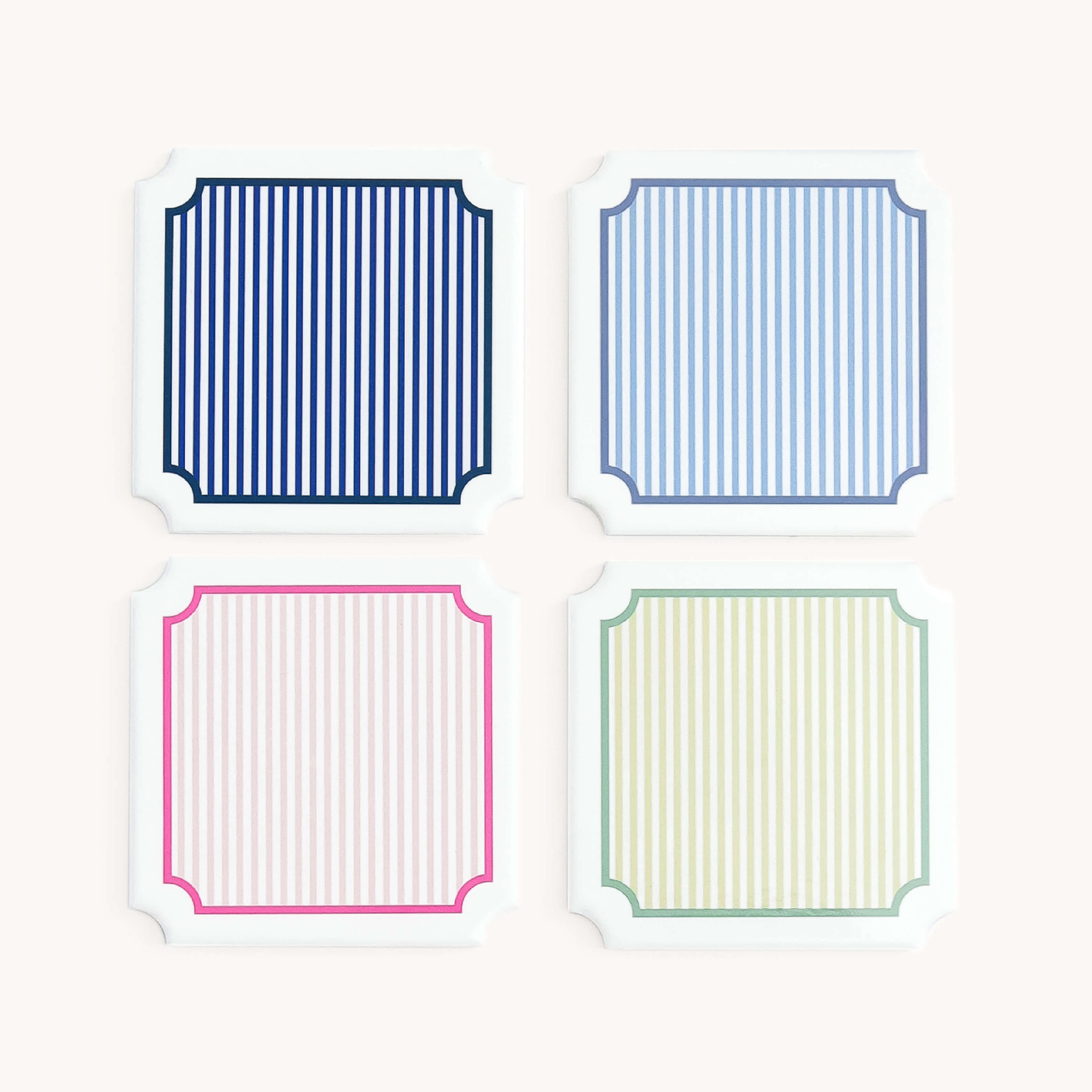 Coaster Set including four rectangular coasters with striped patterns in blue, pink, and green on a white background.