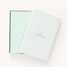 2025 Calendar Year Daily Dapperdesk Planner by Emily Ley featuring the Sea Salt leatherette cover, placed inside a beautiful keepsake box with gold foil detailing designed for stylish storage.