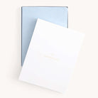 The Simplified 2025-2026 Bookbound Weekly Dapperdesk Planner in Carolina Dot features a leatherette cover with small gold dots and a white overlay embossed with DAPPERDESK 2021 Edition. This sleek planner is perfect for all your scheduling needs.