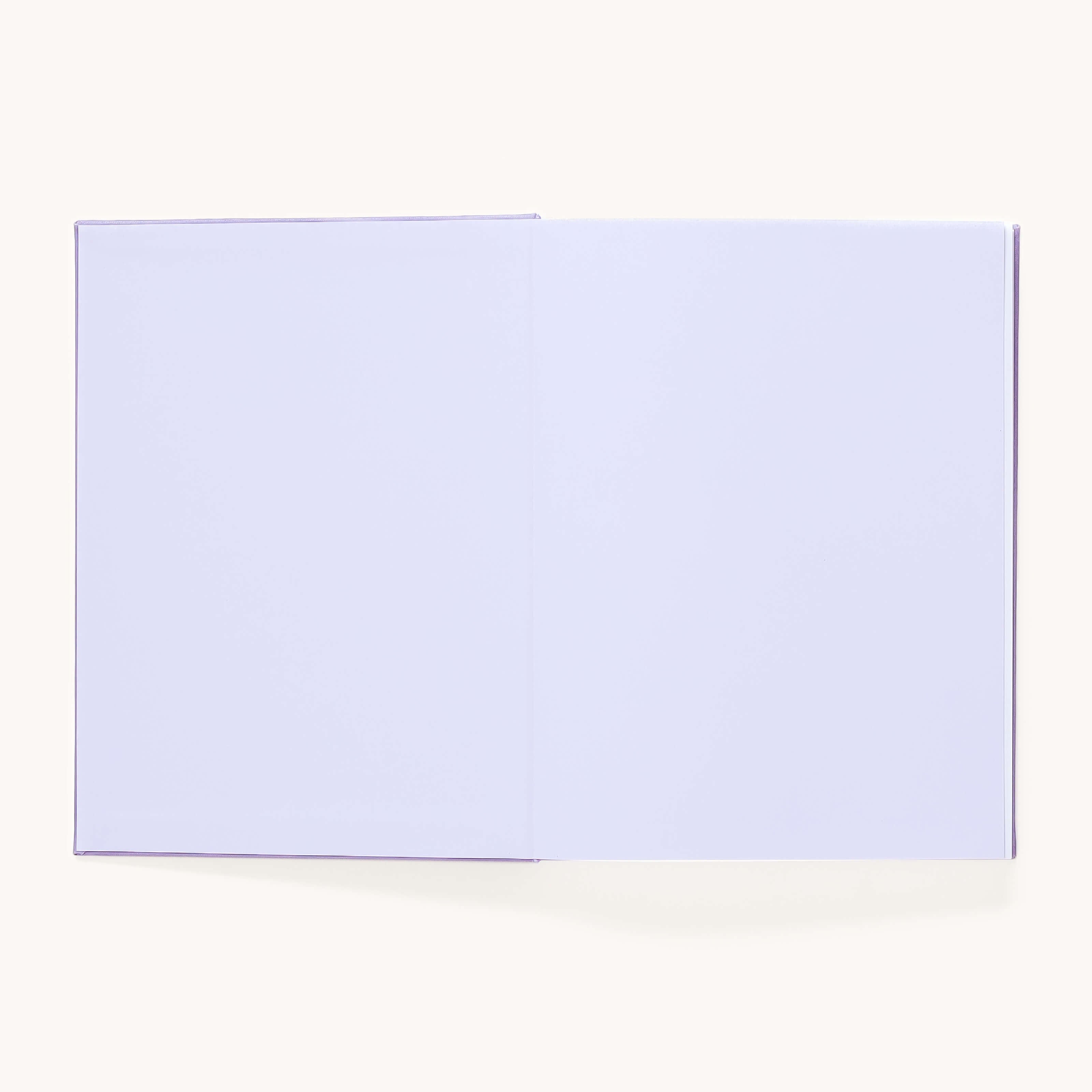 The Simplified Linen Journal - Celestial features a lay-flat linen hardcover and completely blank white pages, shown open against a plain, light background.