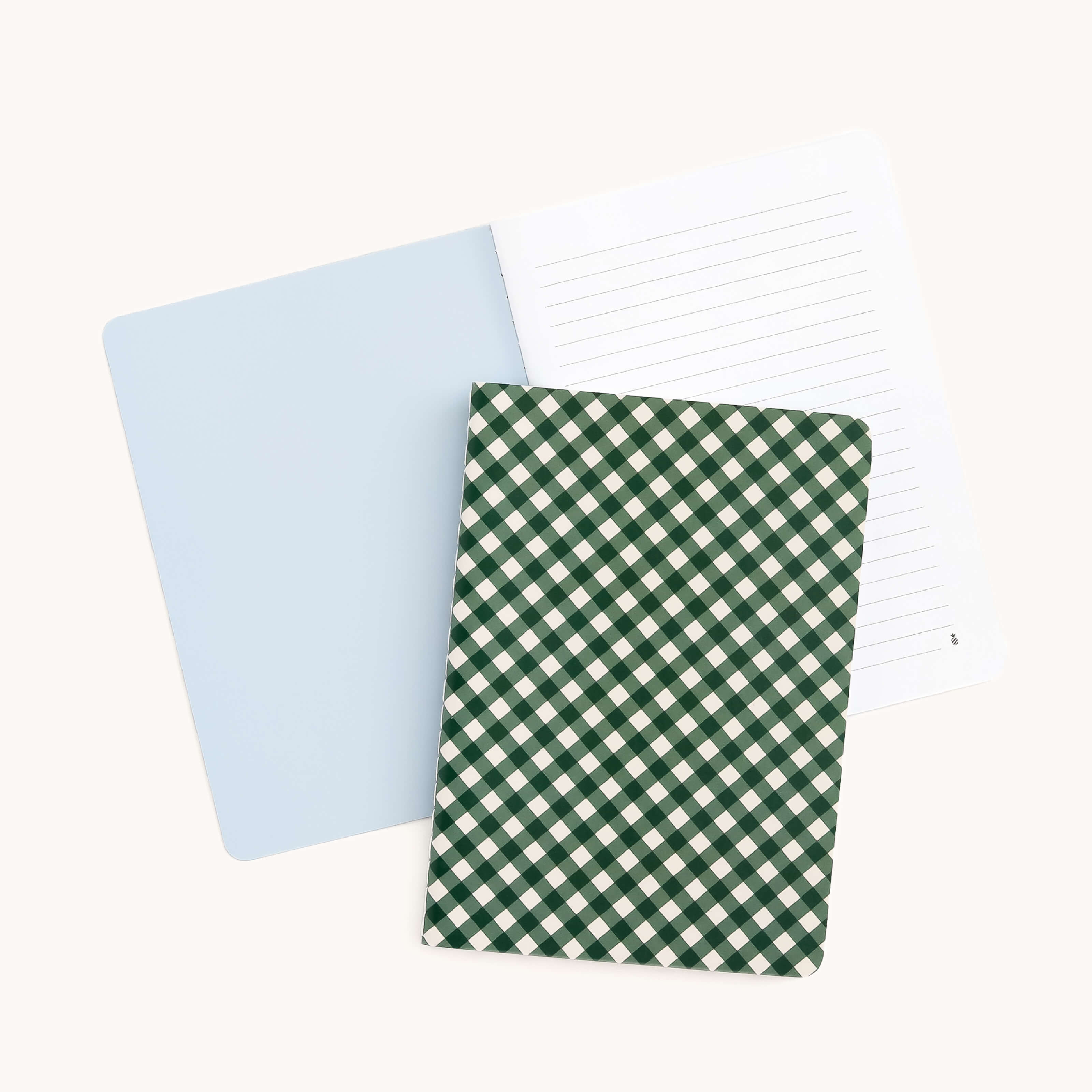 The Simplified Mini Notebook - Camp Gingham features a green and white checkered cover. Its thick, durable paper cover holds lined pages inside, making it a charming choice to jot down your thoughts on any surface.