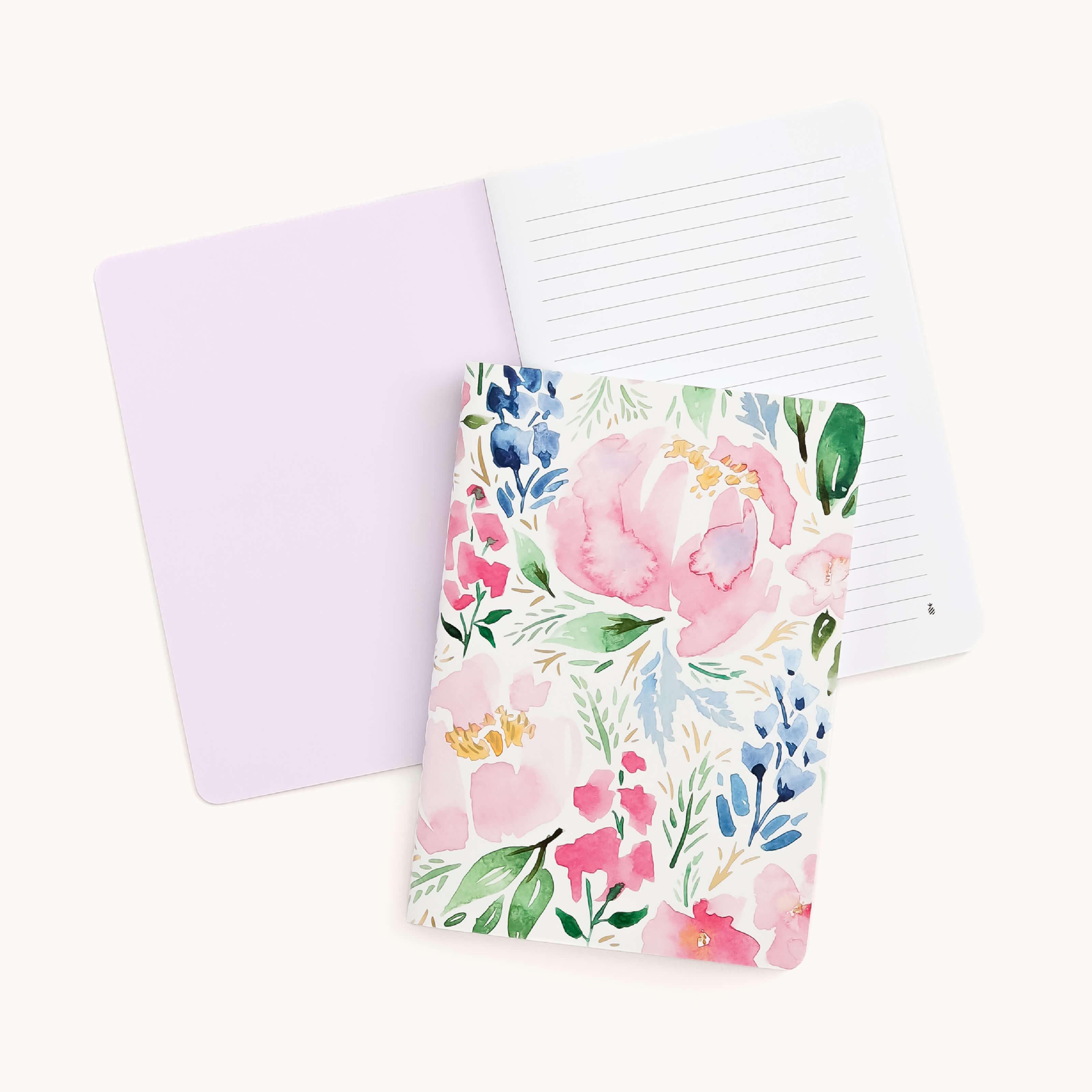 The Mini Notebook - Cottage Floral by Simplified, featuring lined pages and a floral cover with custom pink, blue, and green watercolor patterns, is shown open against a plain light background.