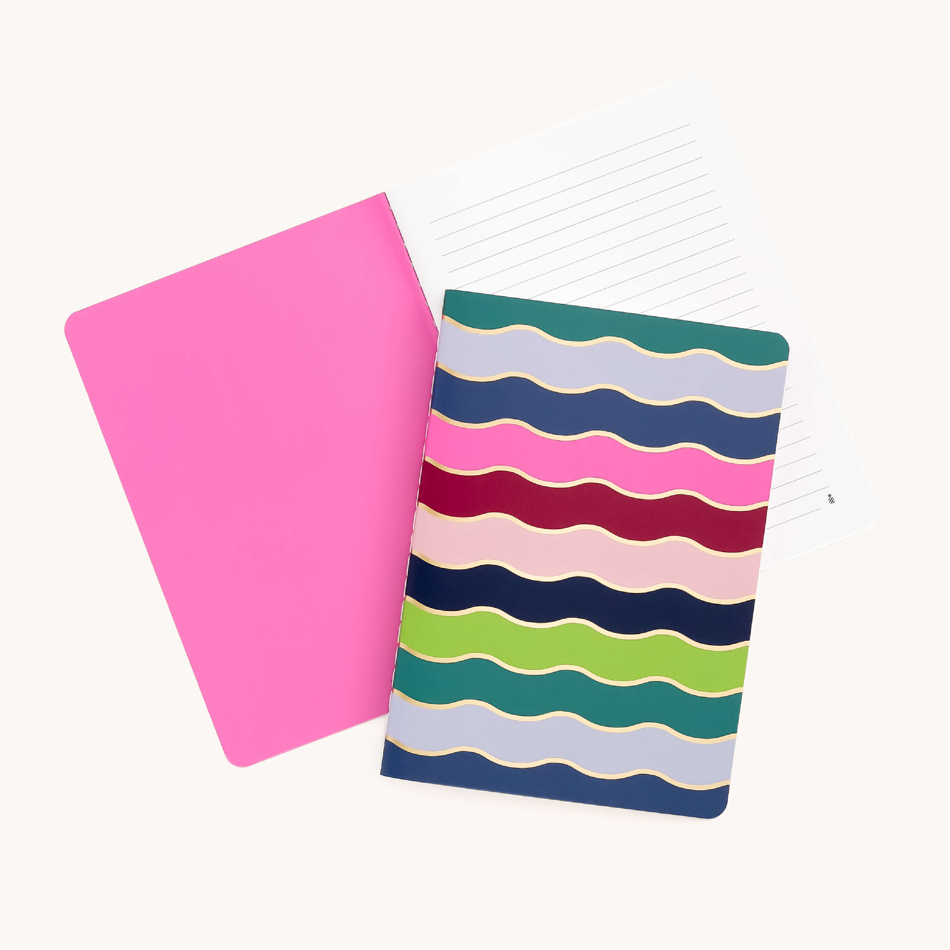 Against a white backdrop, two mini notebooks by Simplified are displayed: one with a pink cover and lined pages, and the Mini Notebook - Rainbow Row, featuring custom patterns of colorful wavy stripes in pink, blue, red, and green with lined pages.