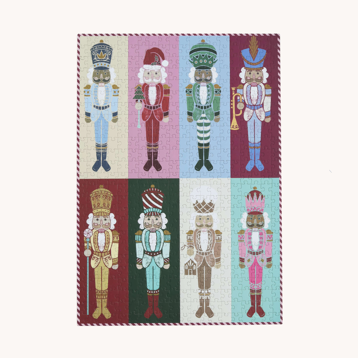 Nutcrackers 500-Piece Jigsaw Puzzle completed: eight hand-drawn nutcrackers on pink, green, blue, and red panels