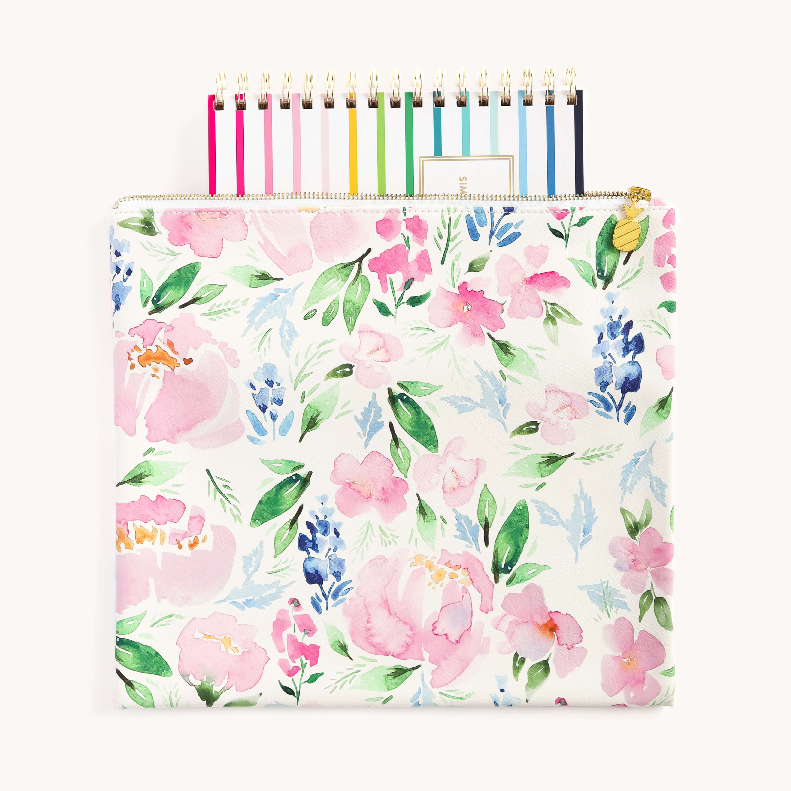 The Simplified Cottage Floral Planner Pouch stylishly secures notebooks with its durable leatherette finish, featuring pink, blue, and green flowers on a white backdrop for an elegant touch.