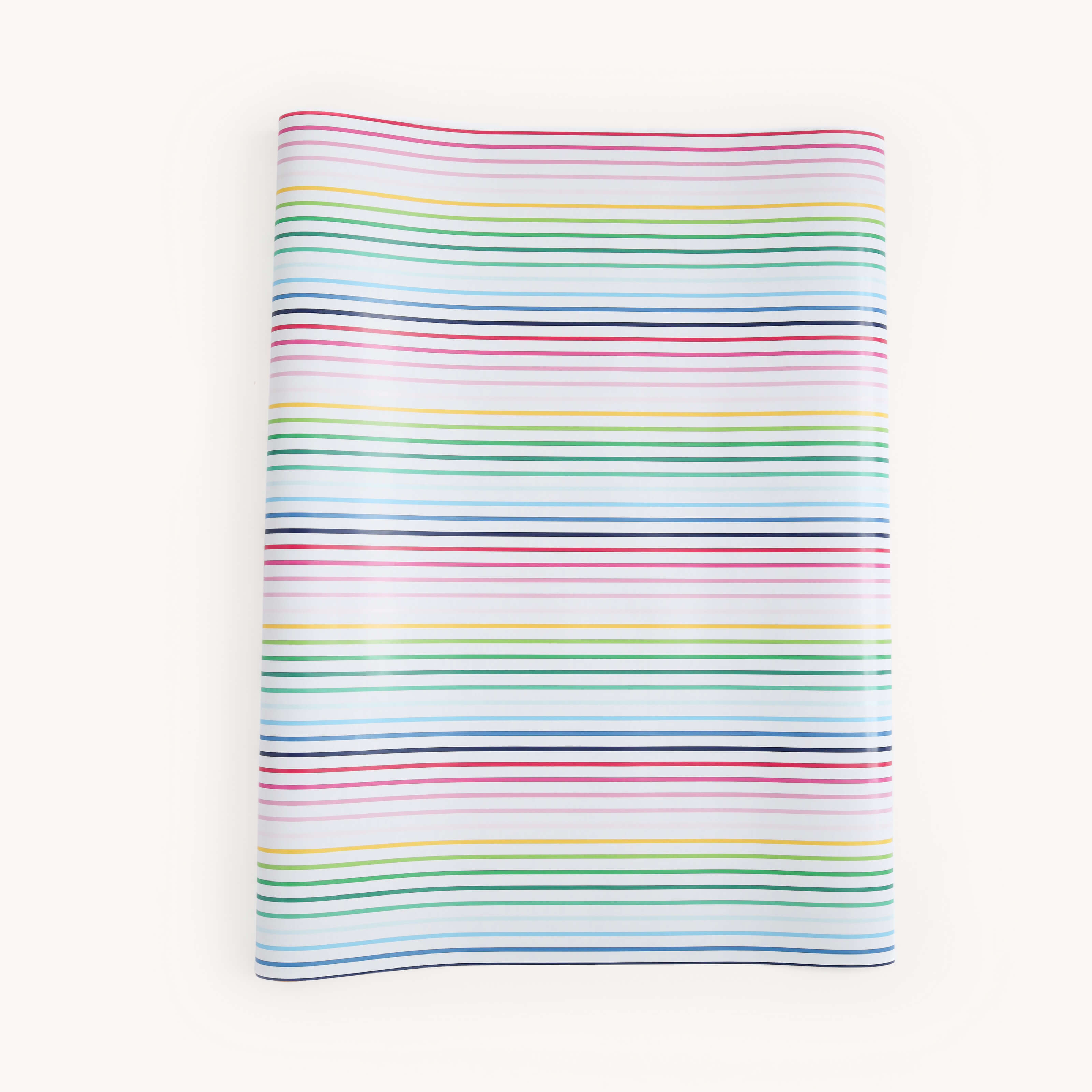 The Simplified Gift Wrap Roll - Happy Stripe features a folded rectangular sheet with horizontal red, green, blue, and yellow stripes on white—a festive way to add charm to your holiday gifts.