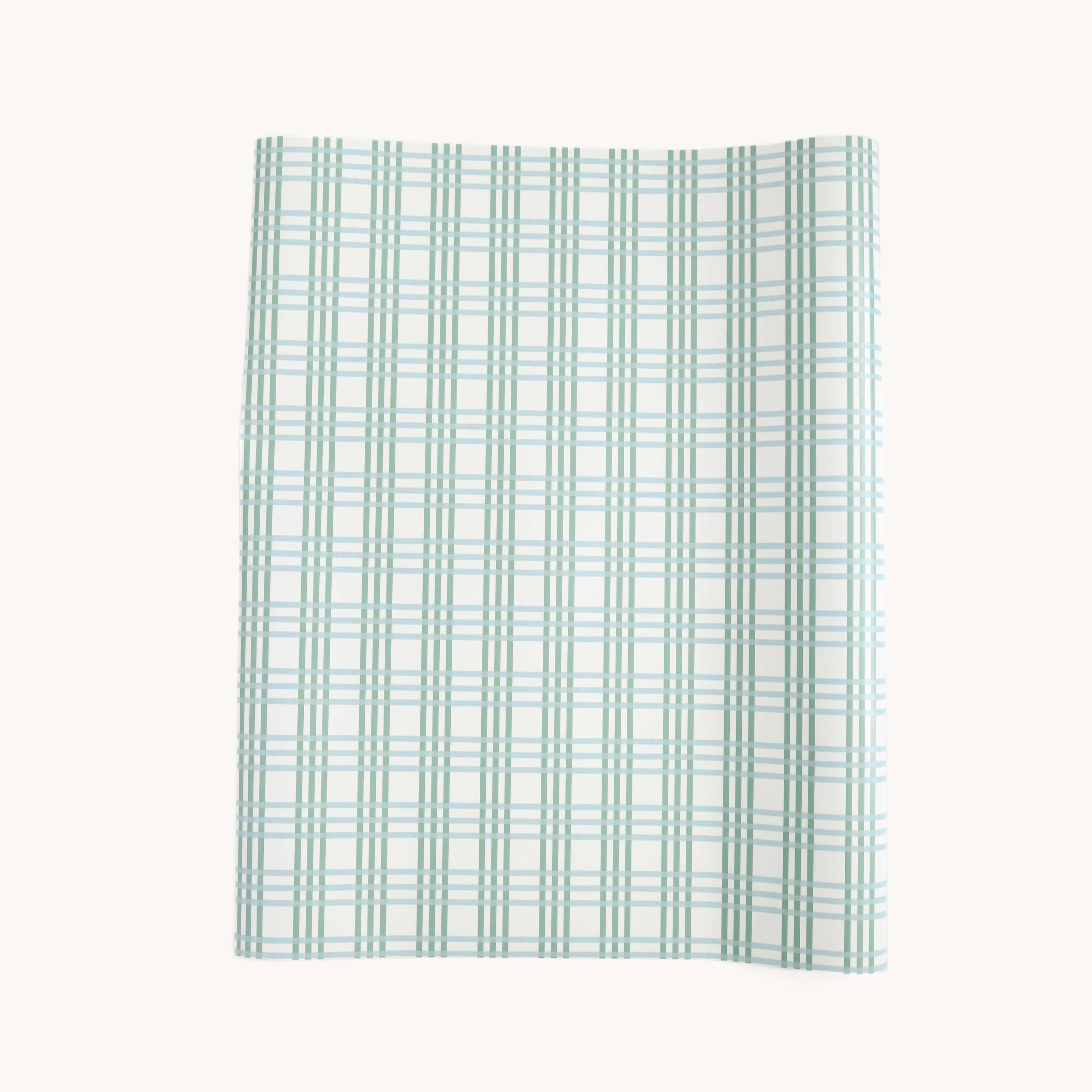 The Simplified Gift Wrap Roll - Pistachio Plaid features a green and blue plaid grid with subtle gold foil accents, shown slightly curled at the top right corner on a plain white background.