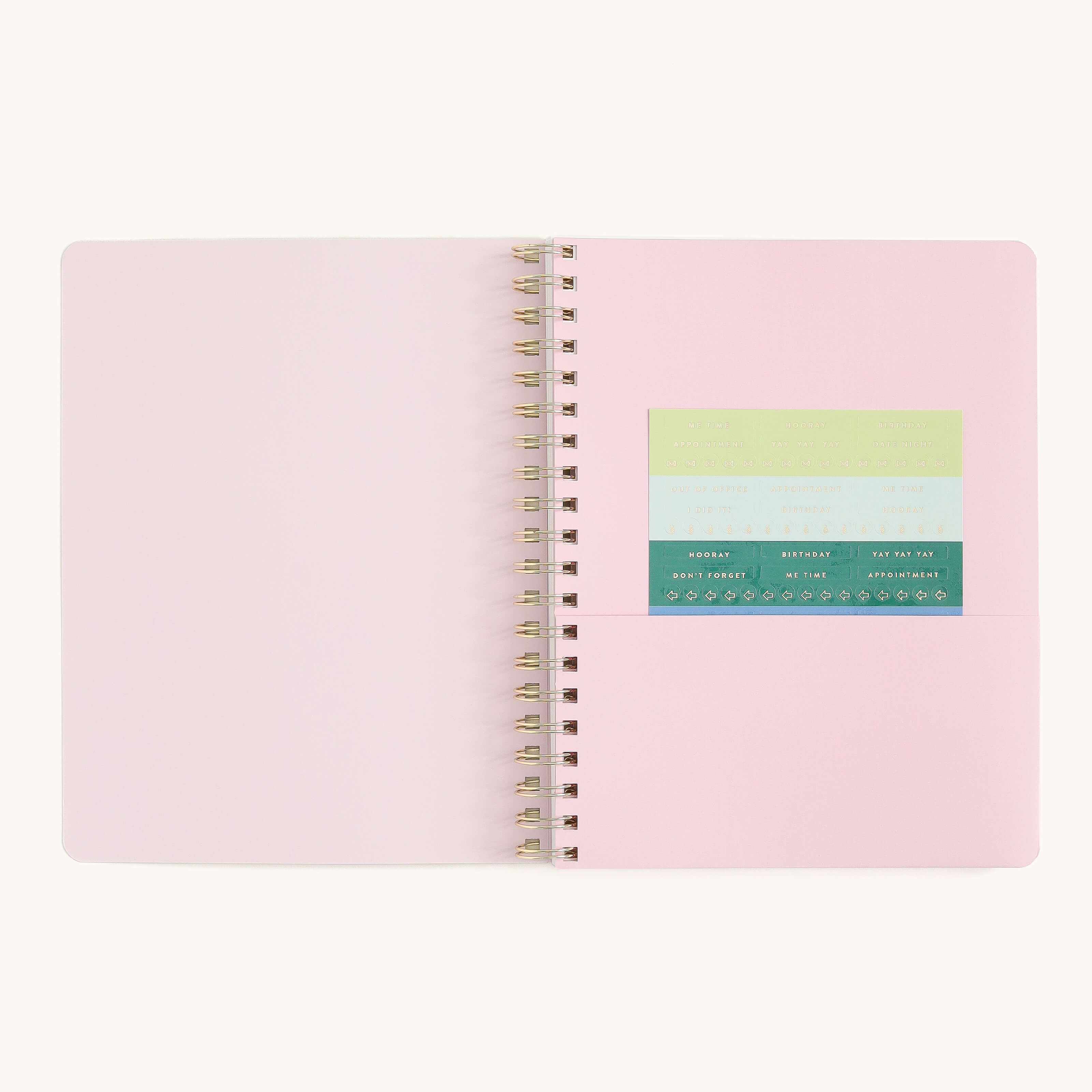 Large softcover weekly planner interior with storage pocket and sticker page for organizing notes, reminders, and weekly plans