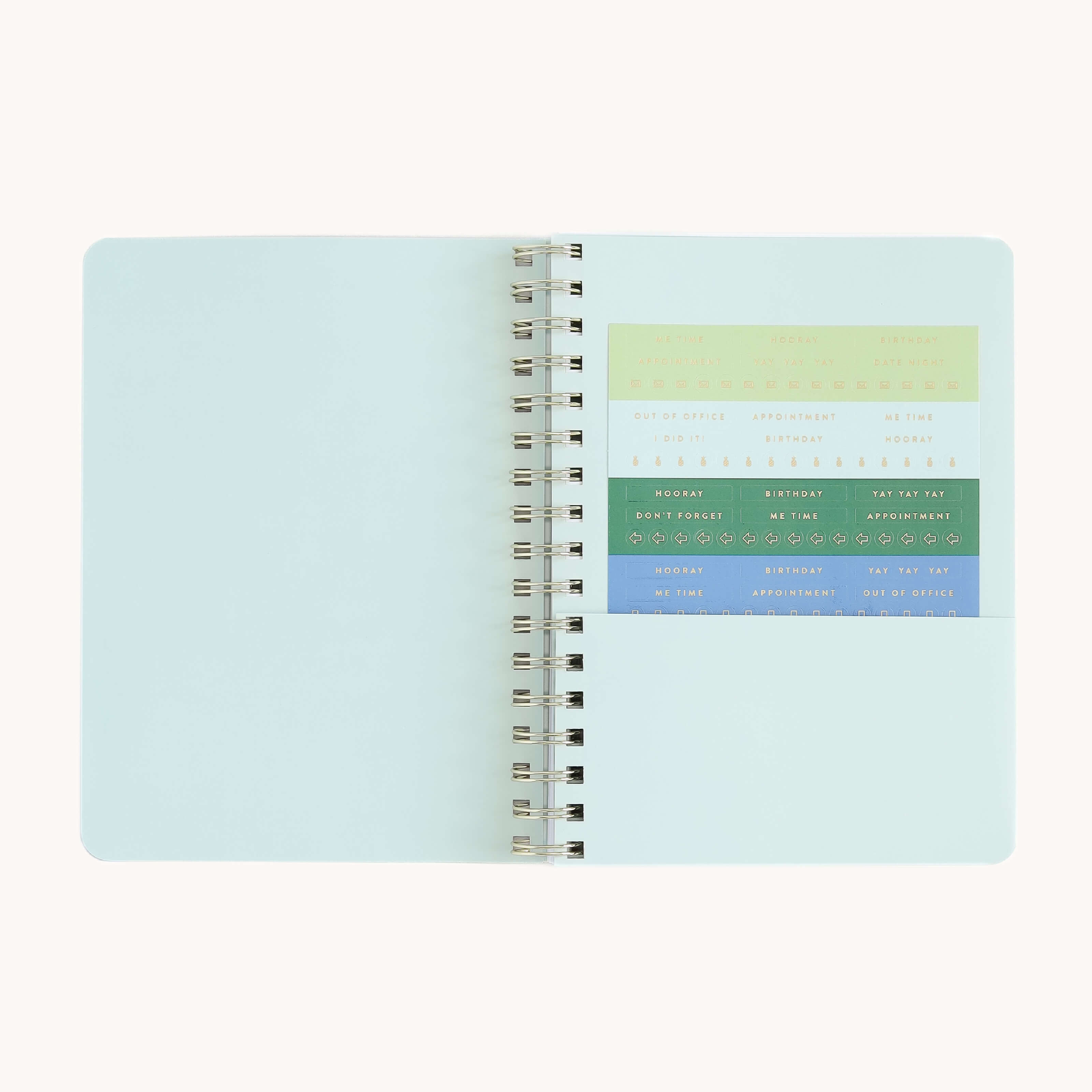 Small softcover weekly planner interior with storage pocket and sticker page for organizing notes, reminders, and weekly plans