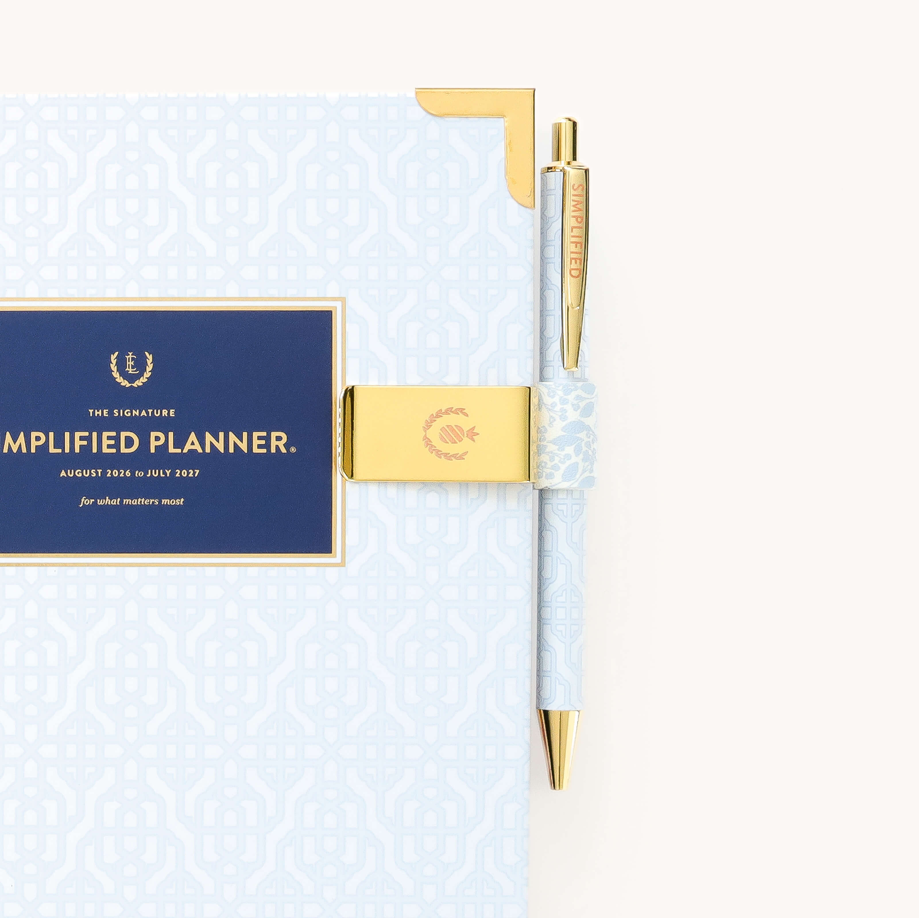 Brass pen clip attached to planner with Misty Meadow design for keeping pens accessible and neatly stored on the go