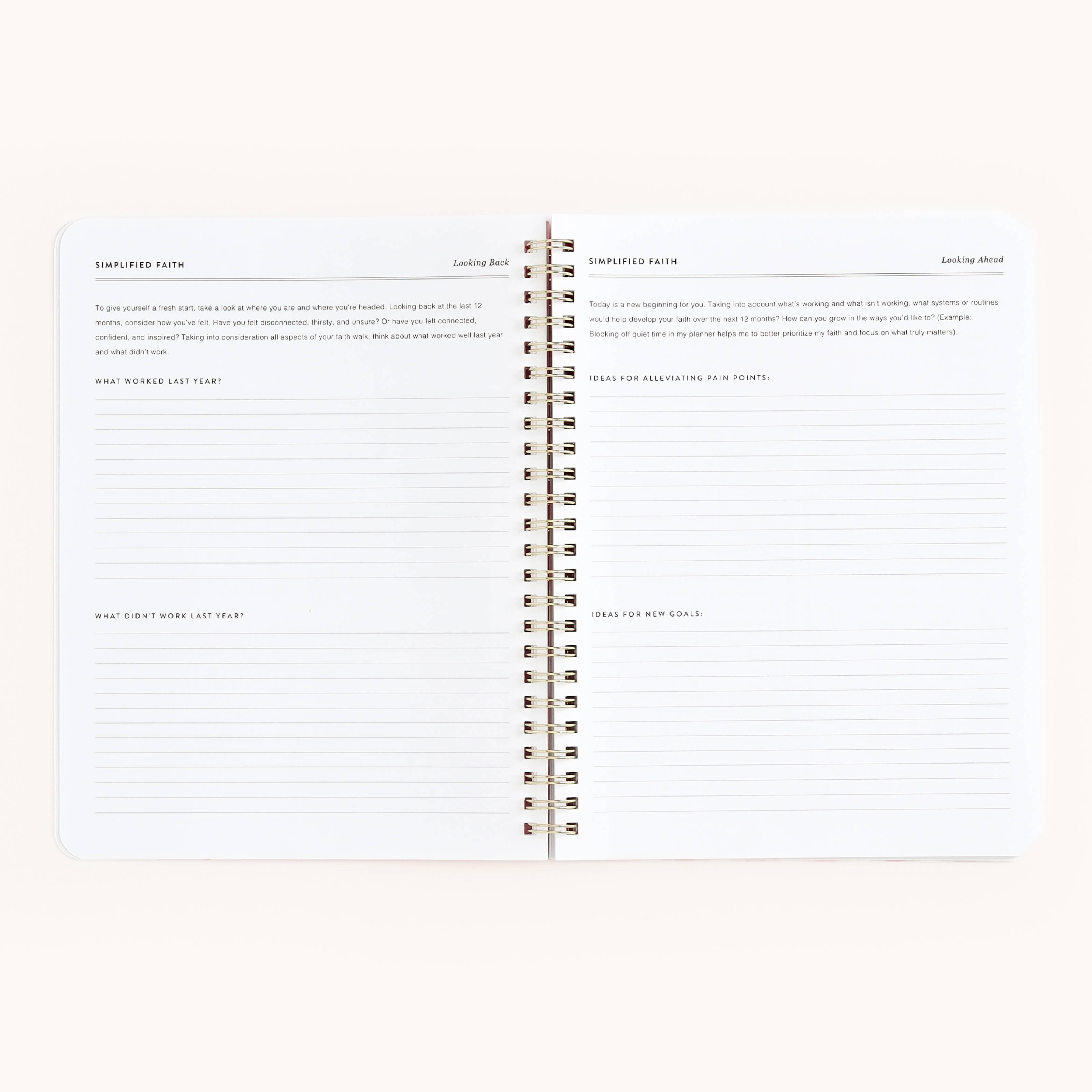 The Simplified Workbook - Faith is an open spiral-bound notebook featuring minimalist pages with prompts and lines for reflections on the past year, faith, lessons learned, growth, change, and actionable plans.