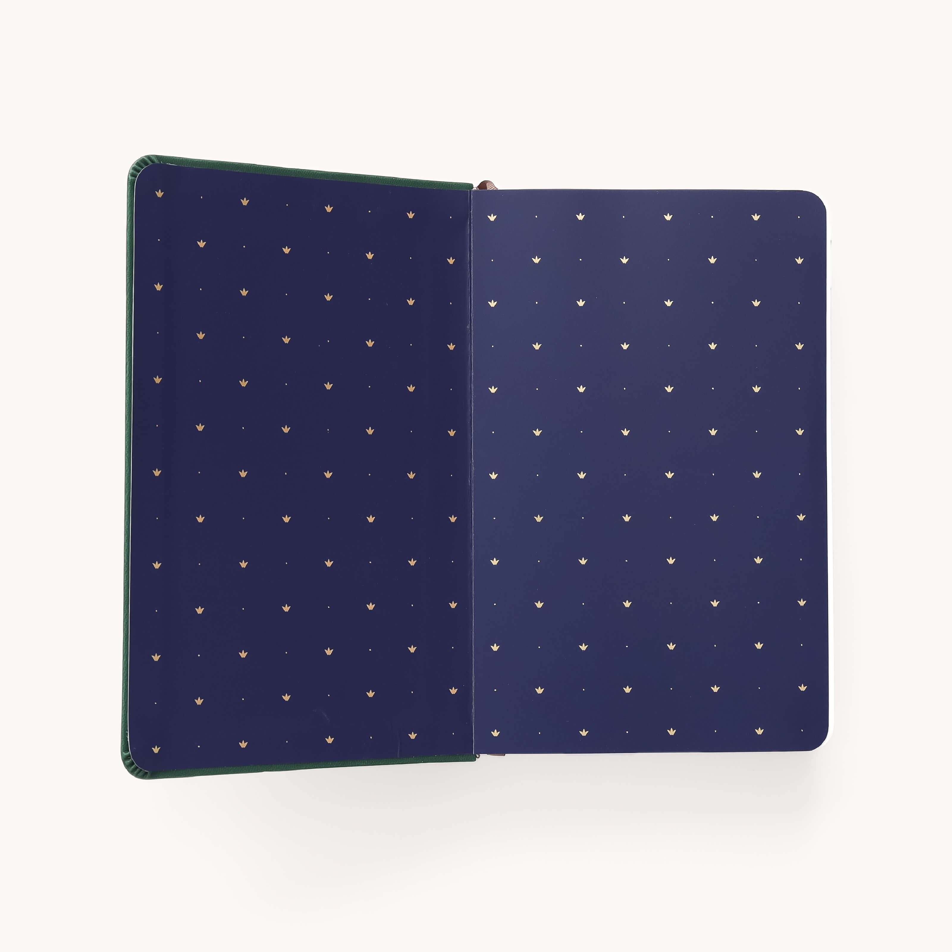 The Simplified 2026 Bookbound Daily Dapperdesk Planner - Evergreen features an open view of the inside cover with a dark blue background and neat gold dot pattern, plus elegant rounded edges for a stylish touch.