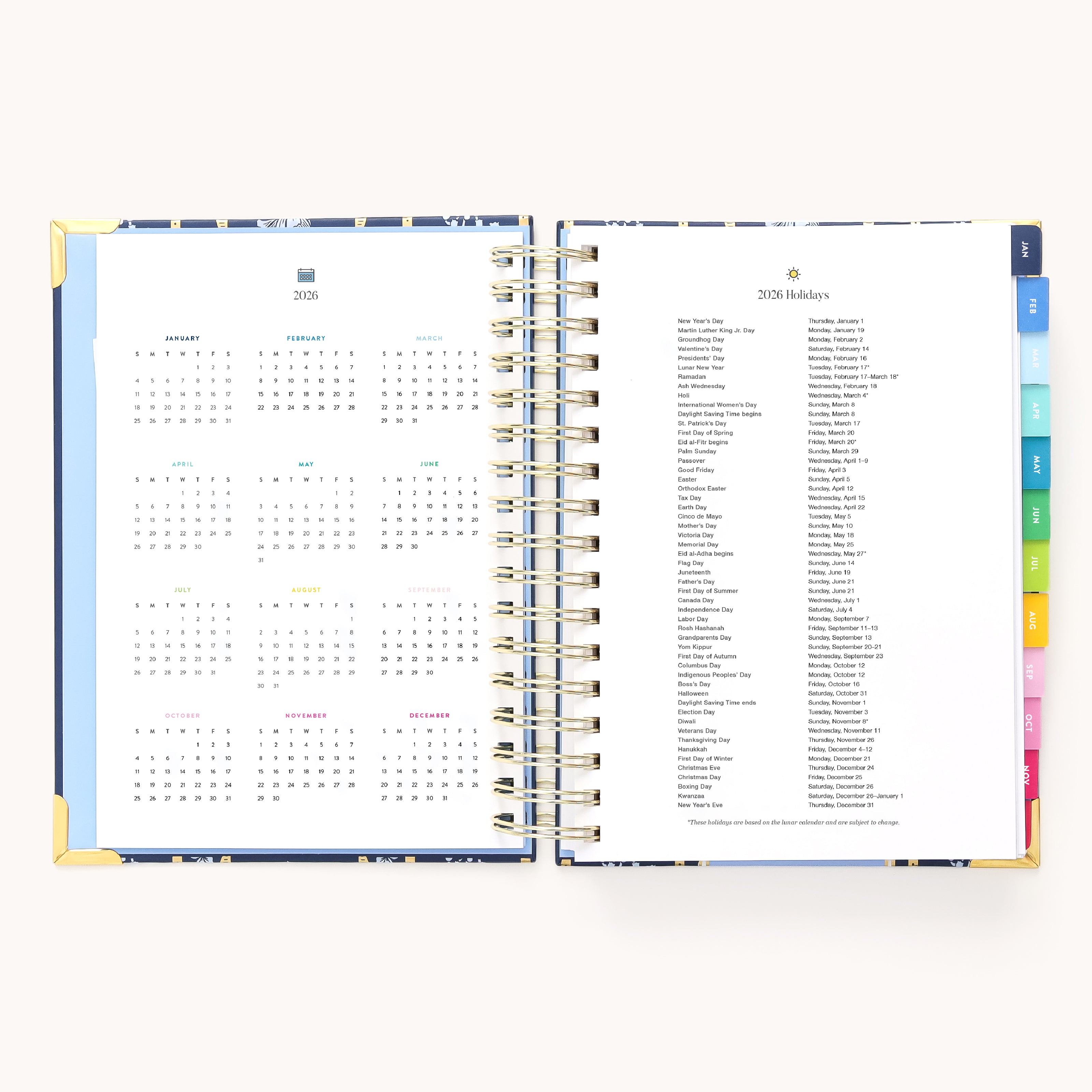 An open 2026 Spiral Daily Simplified Planner - Poppy Posies by Simplified shows a 2026 yearly calendar on the left and a list of 2026 holidays on the right, with colored tabs visible along the page edges.