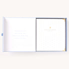 Simplified Wedding Planner by Emily Ley displayed inside its Carolina blue keepsake box. Features a gold foil polka dot cover with ‘Our Wedding’ embossed in gold, protective gold corners, and a timeless 'Something Old, Something New, Something Borrowed, Something Blue' inscription inside the box.