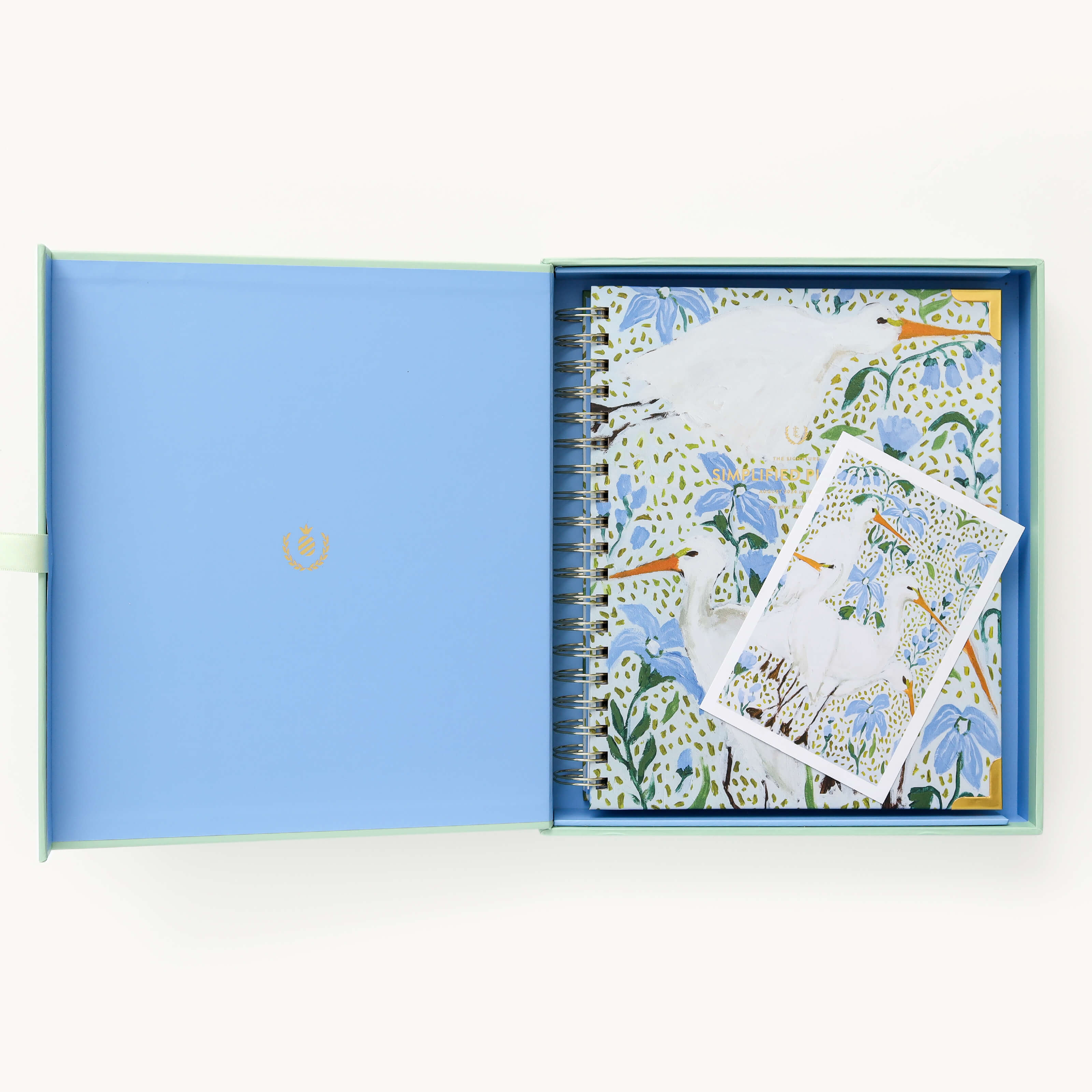 2025 Calendar Year Weekly Simplified Planner by Emily Ley in the Beaufort Birdies cover design, placed inside a light blue and green keepsake box with gold foil detailing. Includes a matching art print for added inspiration. Perfect for organization, time management, and productivity.