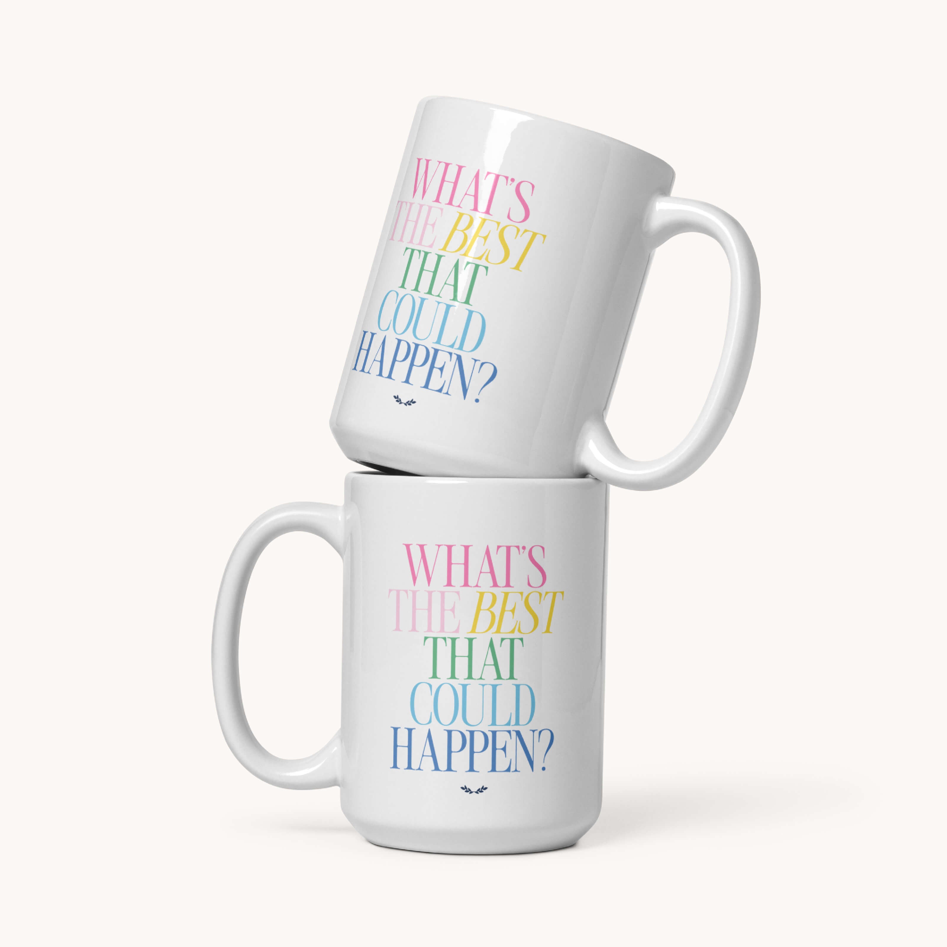 Two 15 oz Simplified "Mug - Best That Could Happen" ceramic mugs stacked, each with “WHAT’S THE BEST THAT COULD HAPPEN?” in pastel pink, yellow, green & blue. Microwave and dishwasher safe. Plain background.