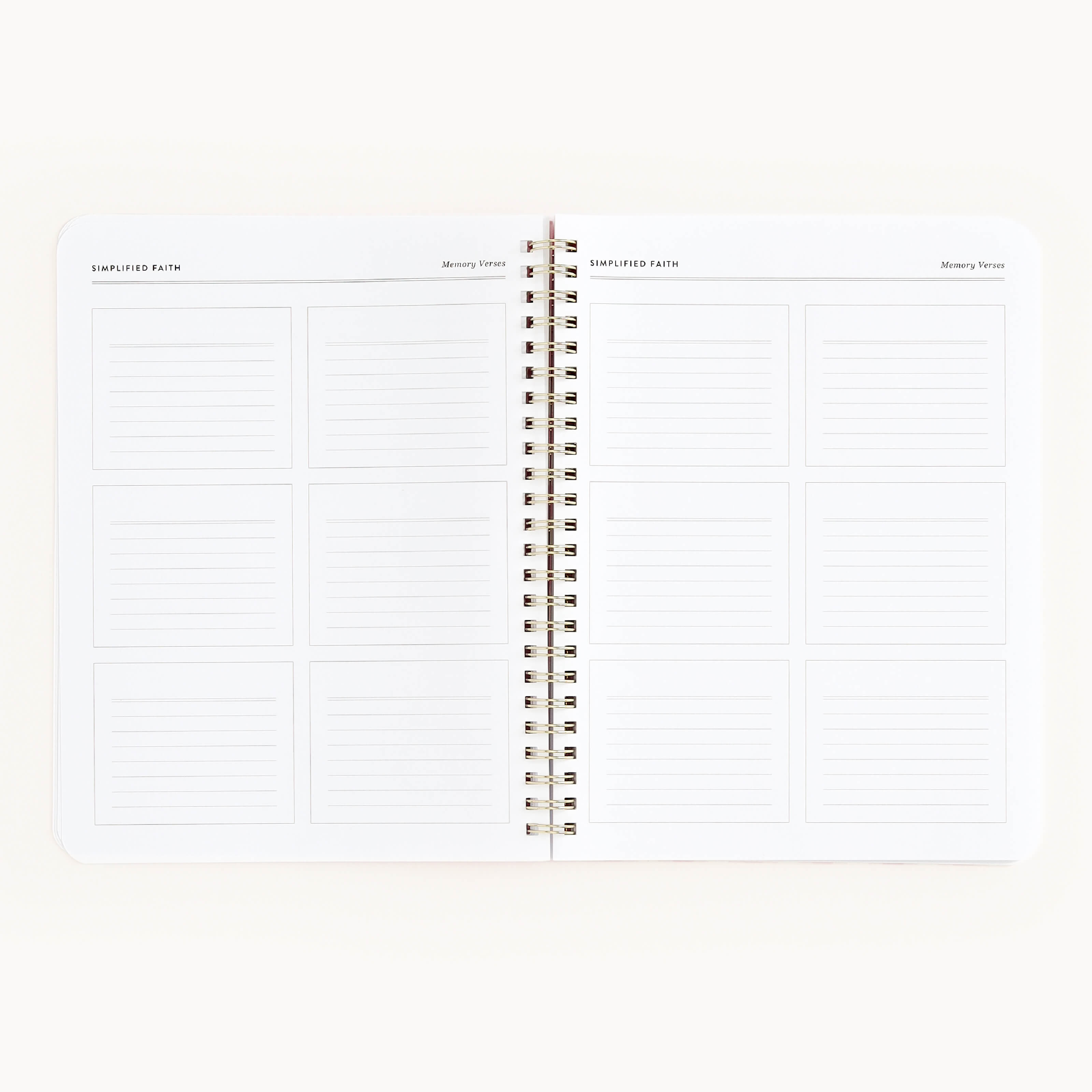 The Simplified Workbook - Faith is an open spiral-bound notebook featuring twelve rectangular lined sections labeled Memory Verses across two pages, set on a plain white background—ideal for recording goals and tracking growth.