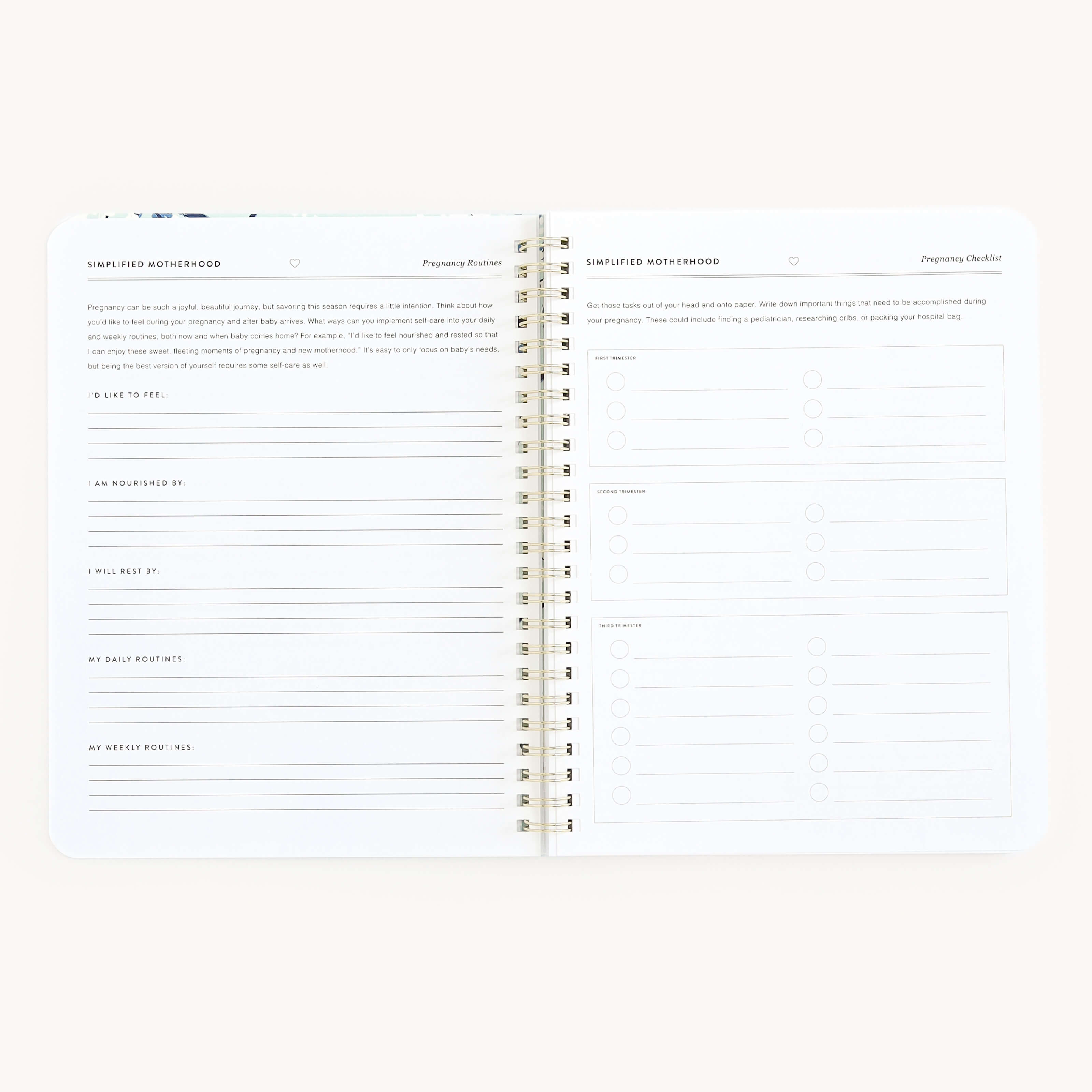 The Simplified Workbook - New Motherhood features an open spiral-bound design against a white background. The left page includes reflections and rituals with prompts like I like to feel and I am nourished by, ideal for busy parents. The right page offers a planning checklist with bullet points and checkboxes.