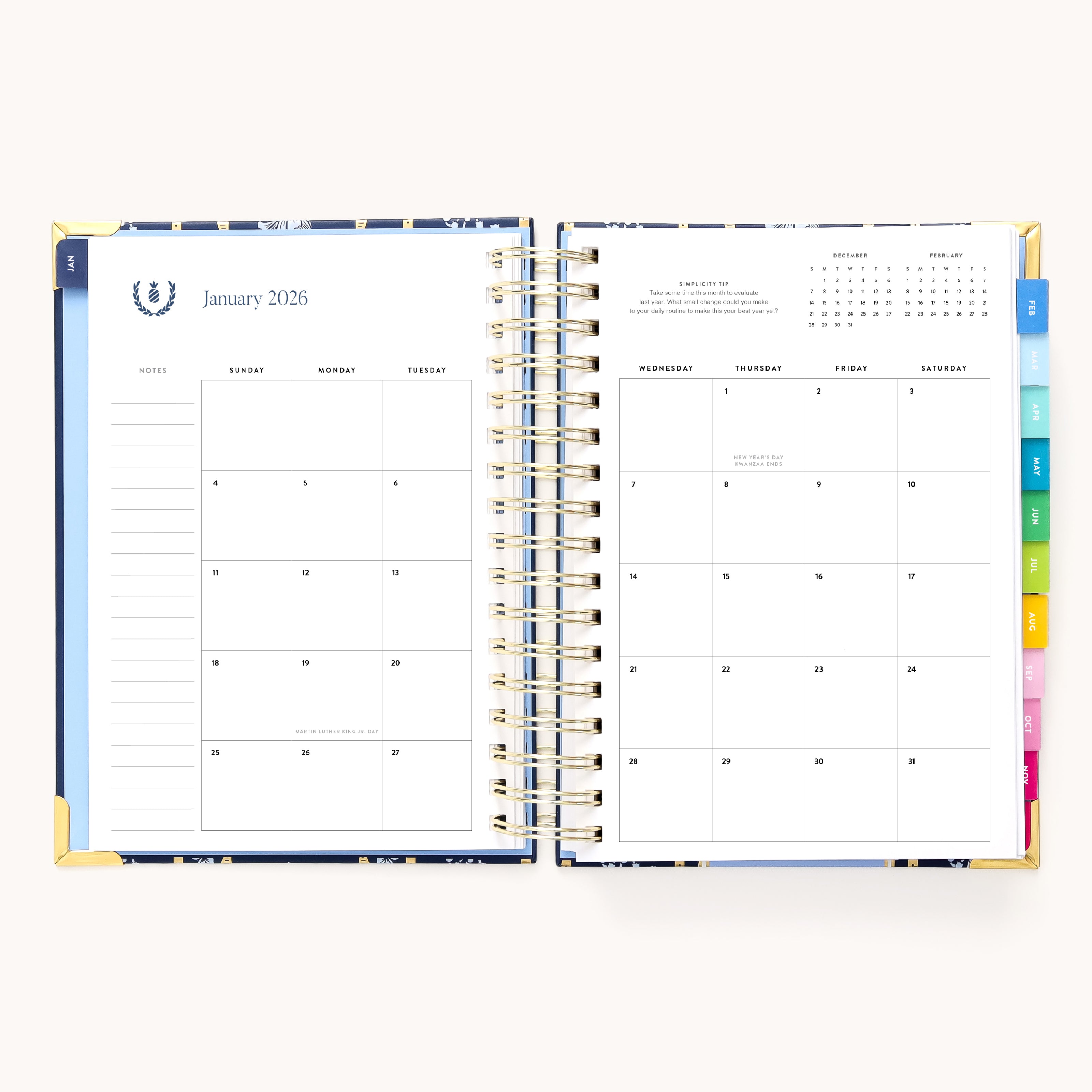 The 2026 Spiral Daily Simplified Planner - Poppy Posies by Simplified opens to January’s monthly view with notes and numbered days on the left, a blank grid on the right, colorful tab dividers, and a mini yearly calendar—perfect for organizing 2026.
