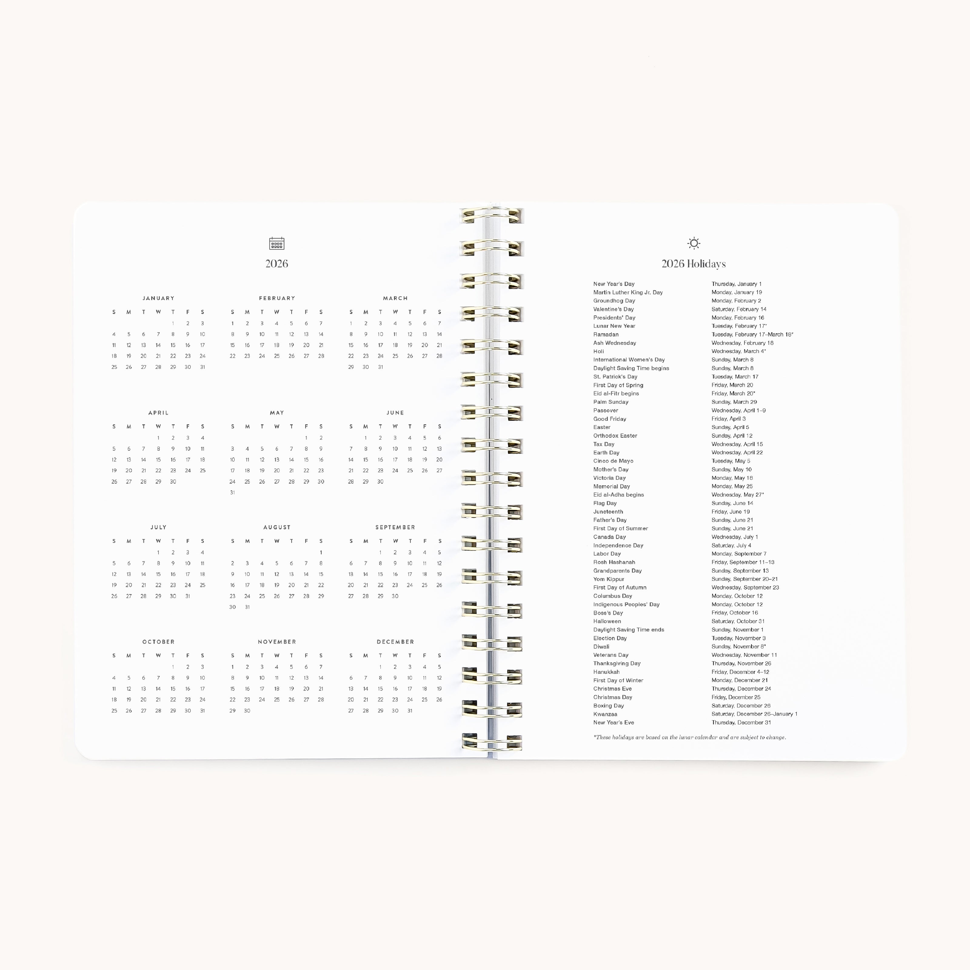An open 2026 Softcover Weekly Simplified Planner - Happy Stripe by Simplified shows a 2026 yearly calendar on the left and a list of 2026 holidays on the right, all in black text on white paper for easy planning.