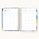 The 2025-2026 Spiral Daily Simplified Planner - Poppy Posies from Simplified showcases an August 2025 calendar over two pages. The left page, embellished with gold foil, has a notes section, while the right begins with Wednesday dates and includes section tabs.