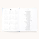 The 2025-2026 Bookbound Weekly Dapperdesk Planner - Carolina Dot by Simplified features a calendar from August to October in a 3x4 grid on the left and holidays on the right, all encased in an elegant leatherette cover against a white background.