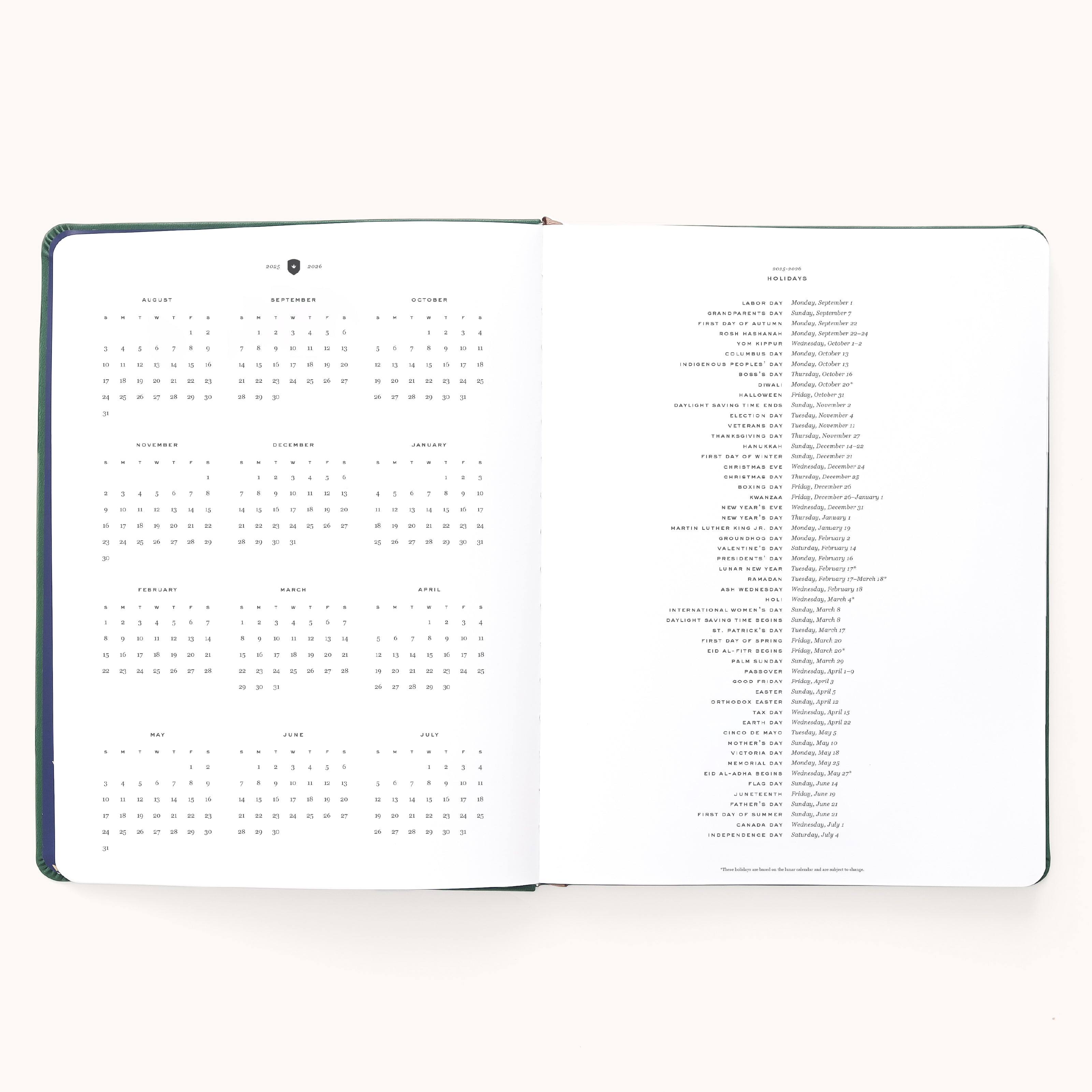 The 2025-2026 Bookbound Weekly Dapperdesk Planner - Evergreen by Simplified features a yearly calendar with months in a grid on the left, international holidays listed vertically on the right, and a sleek leatherette cover—all against a plain white background.