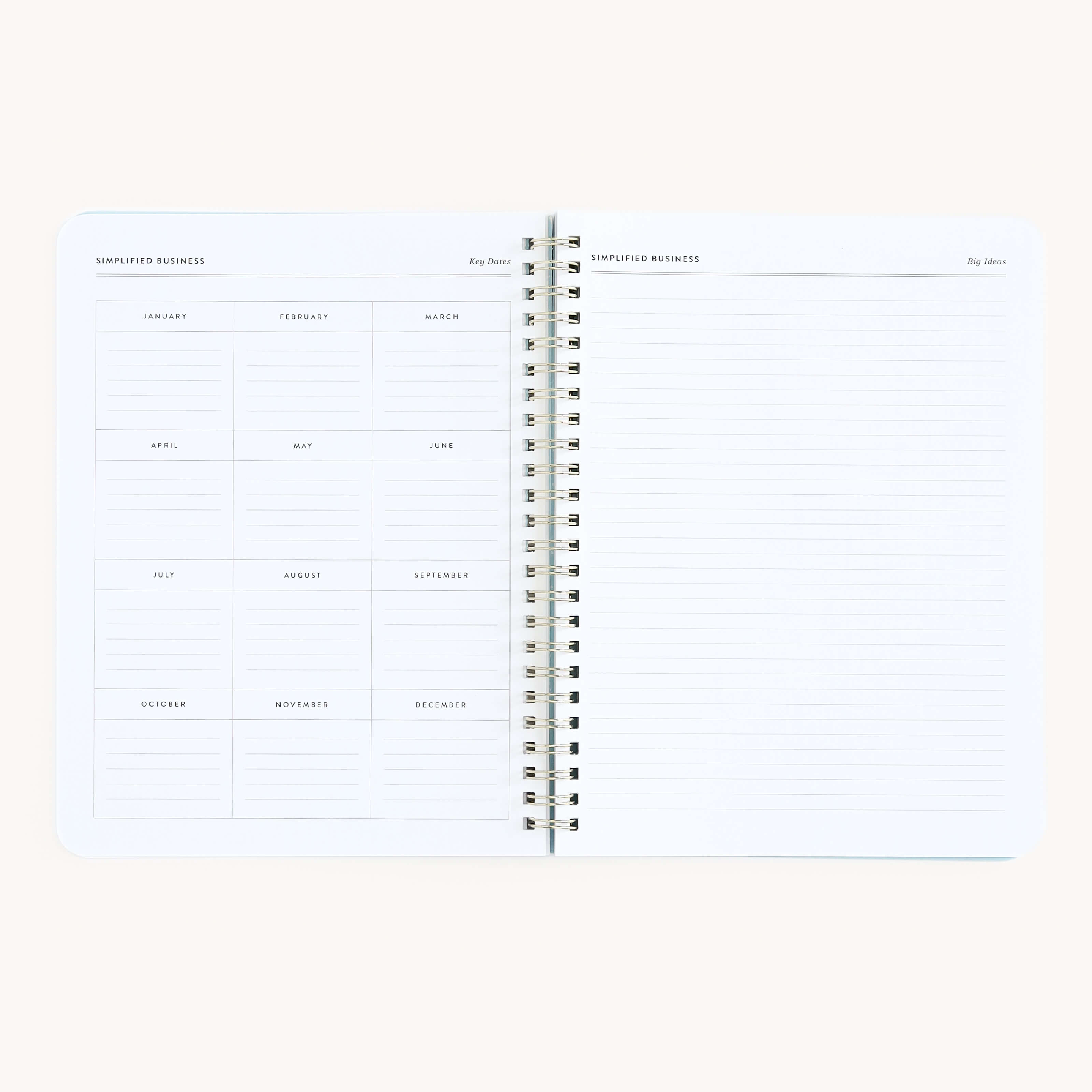 The Simplified Workbook - Entrepreneurship features an open spiral notebook on a neutral background. The left page displays a monthly calendar layout, while the right page includes lined sections titled Key Dates and Key Actions, ideal for planning with a minimalist design.