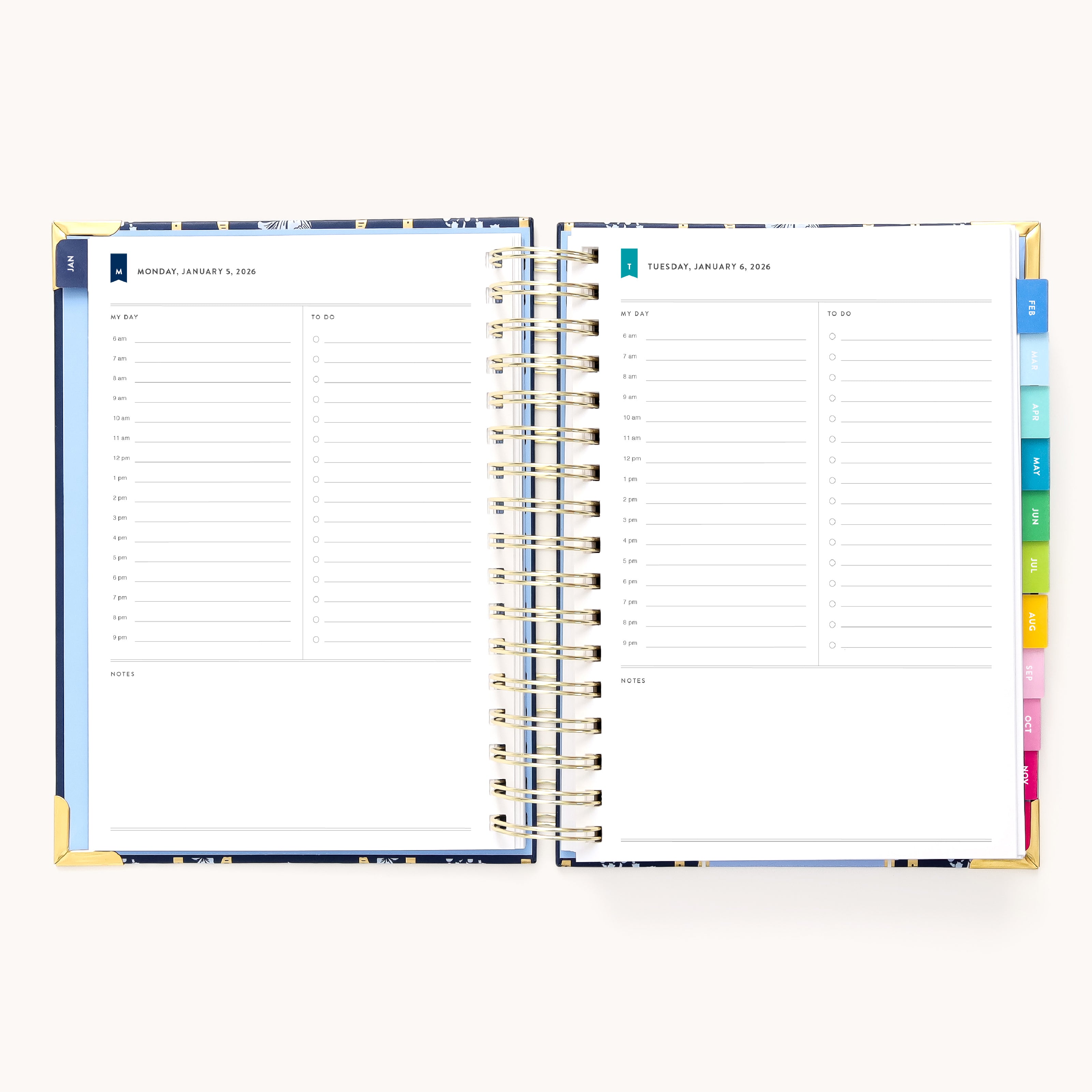 The 2026 Spiral Daily Simplified Planner – Poppy Posies by Simplified is open to Monday and Tuesday daily pages with hourly slots, a notes section, and colorful laminated monthly tabs on an off-white background—ideal for staying organized in 2026.