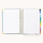 The 2025-2026 Spiral Daily Simplified Planner by Simplified features lined pages, gold foil details, and colorful tabbed dividers on the right. The open flat design reveals Notes on the left page, perfect for your Simplified Prep Work.