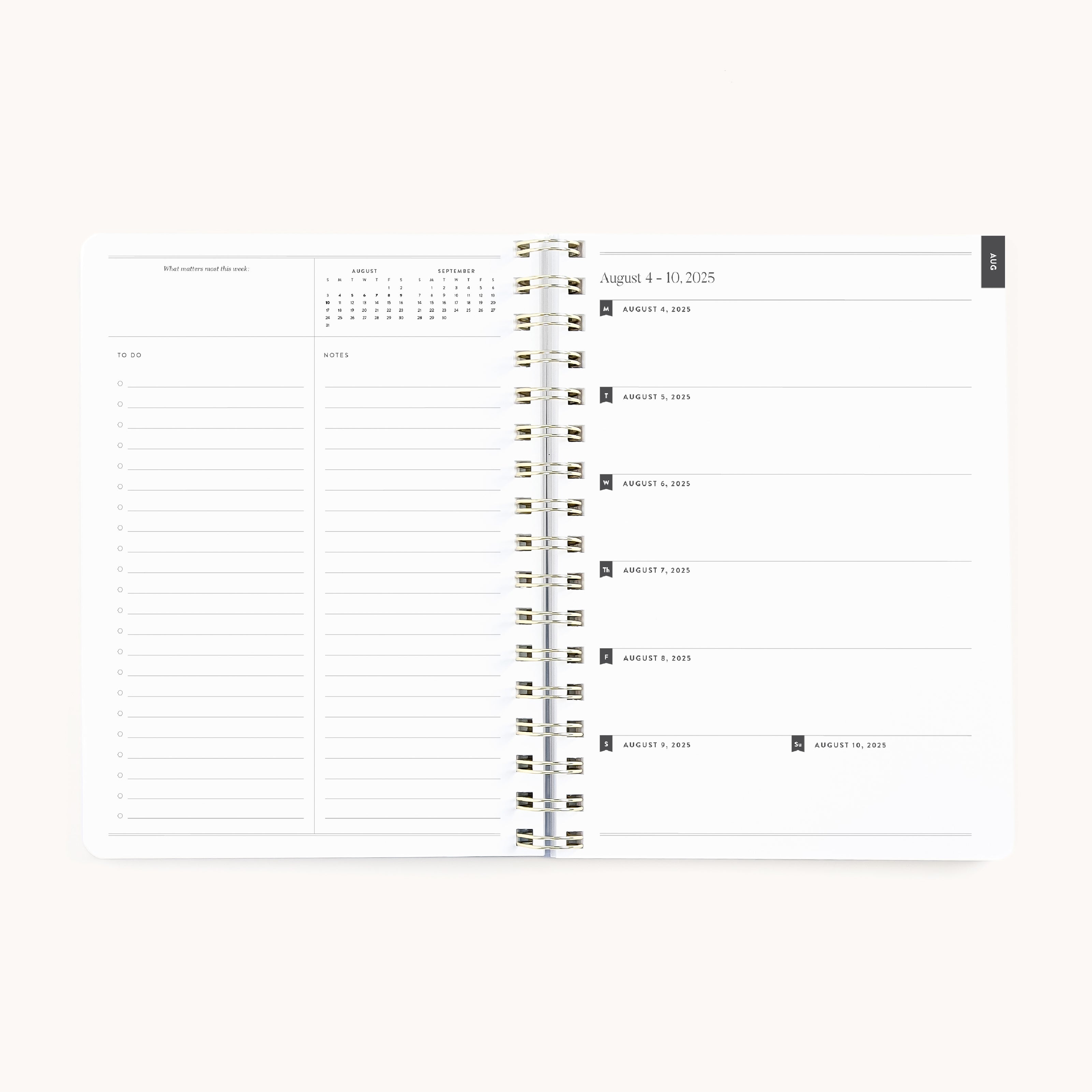 The Simplified 2025-2026 Softcover Weekly Planner in Ivory Antelope features a weekly layout for August 4-10, 2025. With gold foil accents, it includes to-do lists, notes, and daily entries on crisp white pages with black text and calendar previews of past and future months at the top.