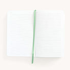 2025 Daily Dapperdesk Planner in the Sea Salt leatherette cover open to the notes pages. Features a two-page spread with blank lined notes pages and ivory grosgrain ribbon page marker.