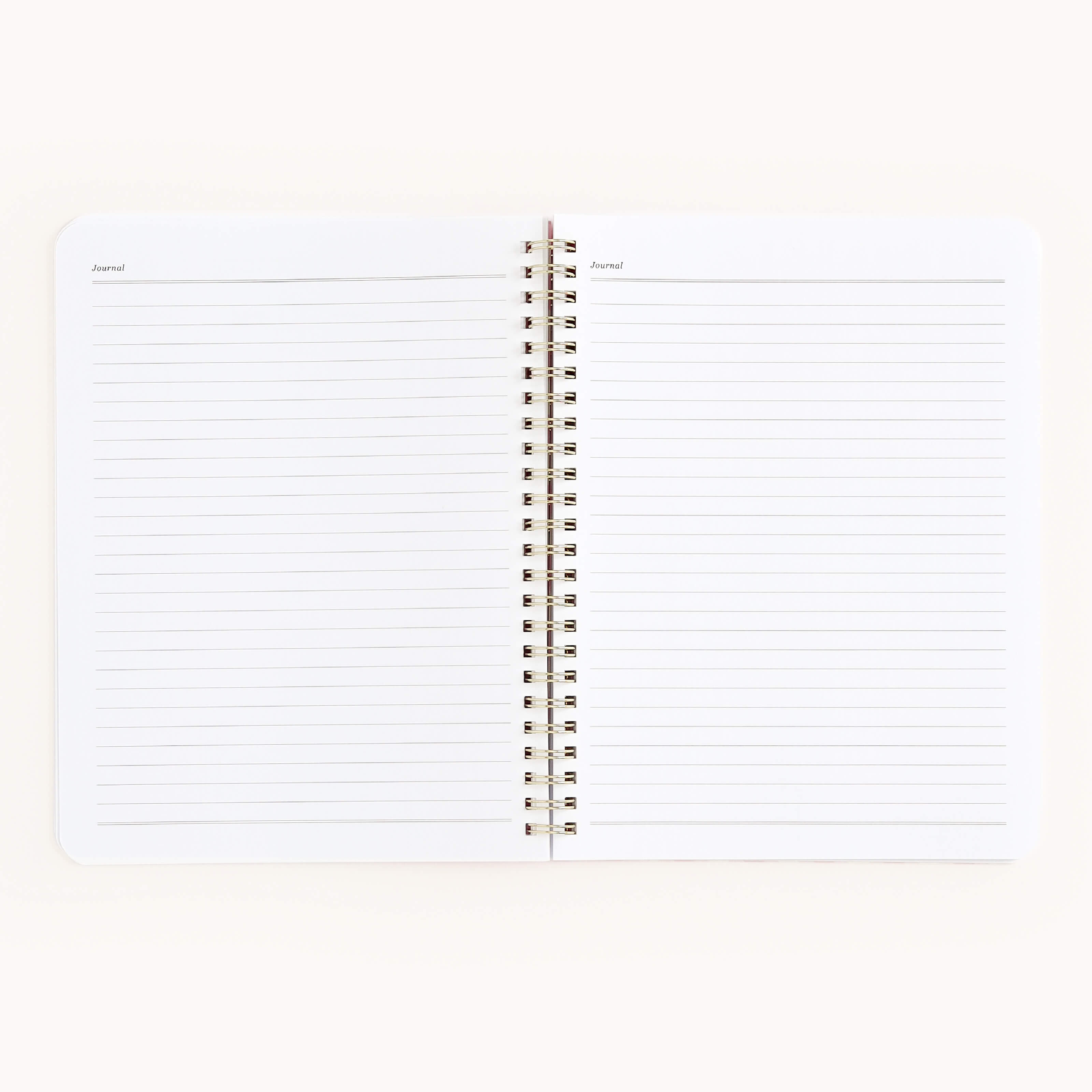 An open spiral-bound Simplified Workbook - Faith with lined pages and Journal at the top of each page lies flat on a white surface—ideal for capturing goals and tracking personal growth.