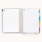 An open 2026 Spiral Daily Simplified Planner – Camp Gingham by Simplified displays two pages with hourly schedules from 7 AM to 8 PM, note sections, and colorful side tabs. The dates shown are Wednesday, January 7, and Thursday, January 8.