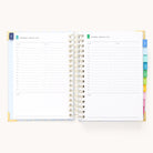 An open 2026 Spiral Daily Simplified Planner - Serene Stripe by Simplified displays two blank daily pages with time slots, notes sections, and colorful tab dividers, shown for Wednesday and Thursday.