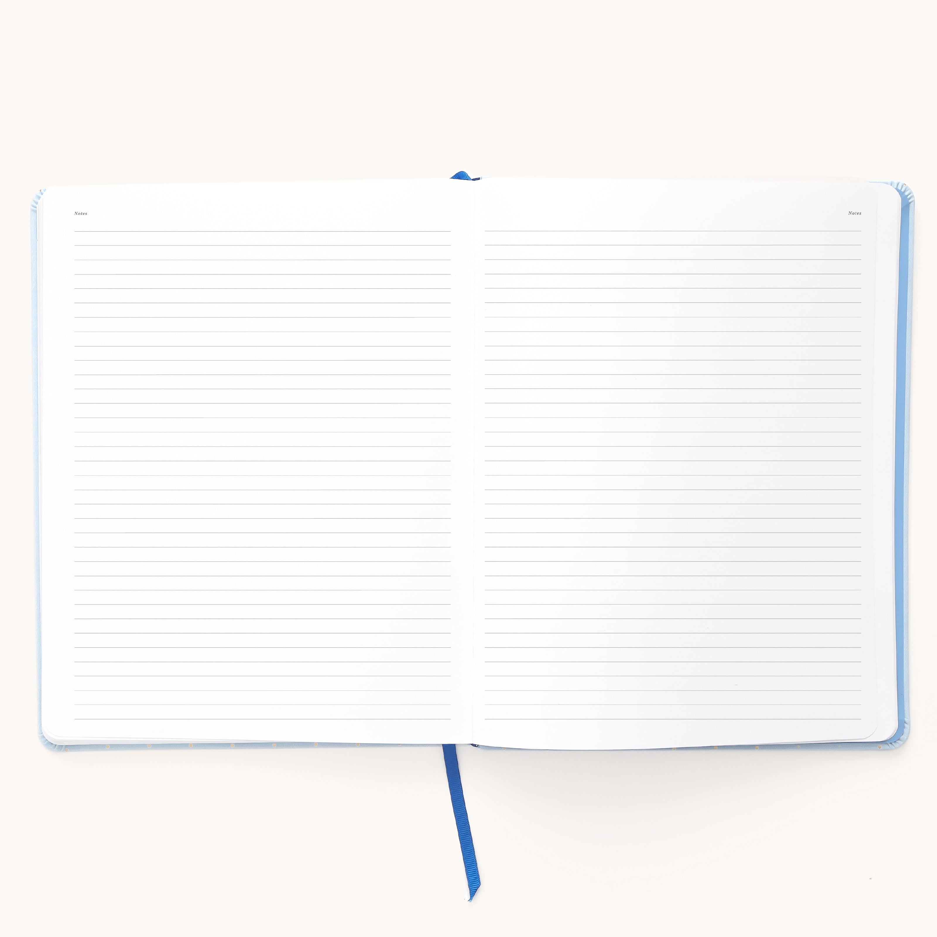 The Simplified 2026 Bookbound Weekly Dapperdesk Planner - Carolina Dot features a lined interior, blue ribbon bookmark, and leatherette cover—perfect for organizing your weeks as a stylish 2026 planner.
