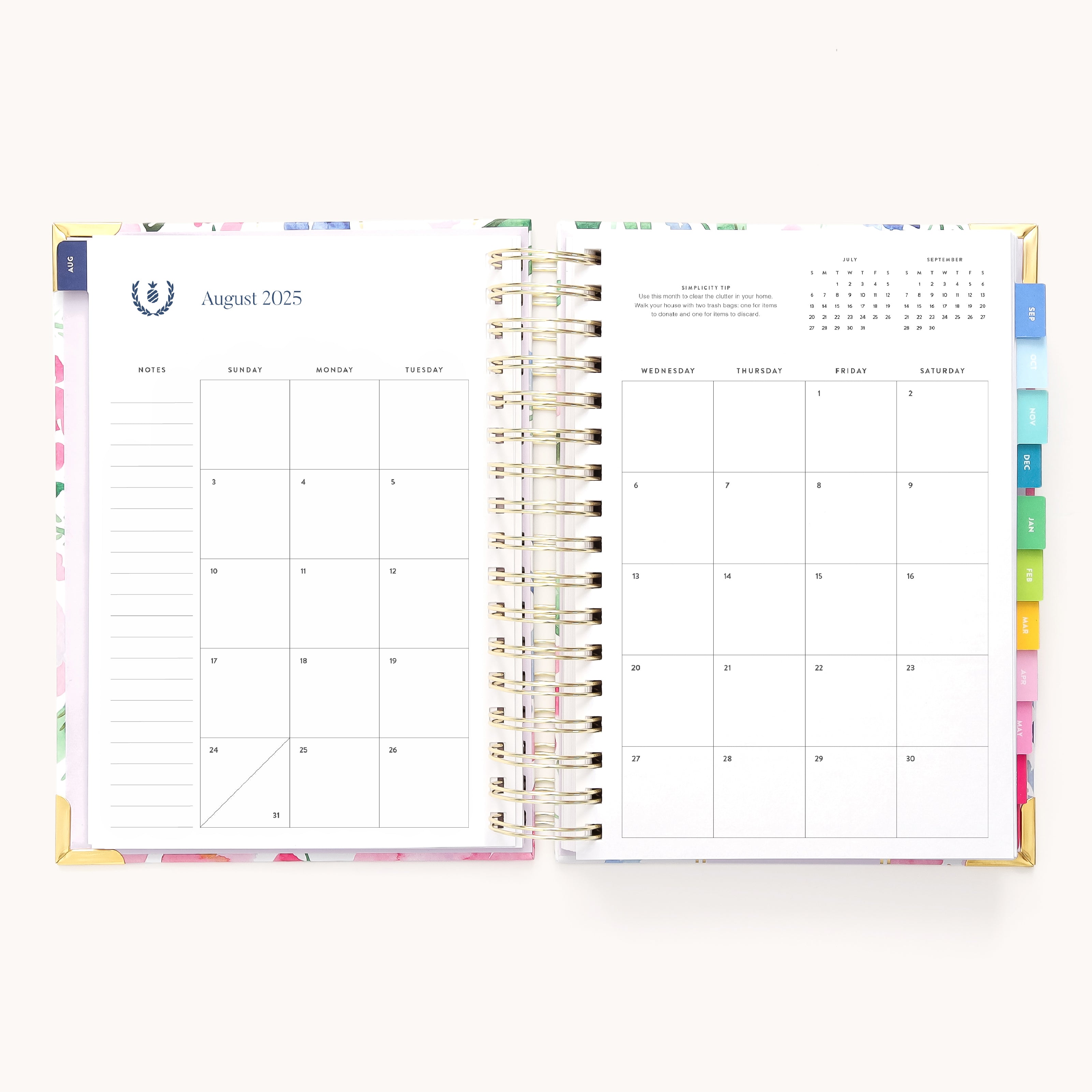 The 2025-2026 Cottage Floral Spiral Daily Simplified Planner by Simplified showcases an August 2025 calendar with a notes section on the left and dates with a small monthly overview and gold foil details on the right. Multicolored index tabs line the edge for easy preparation.