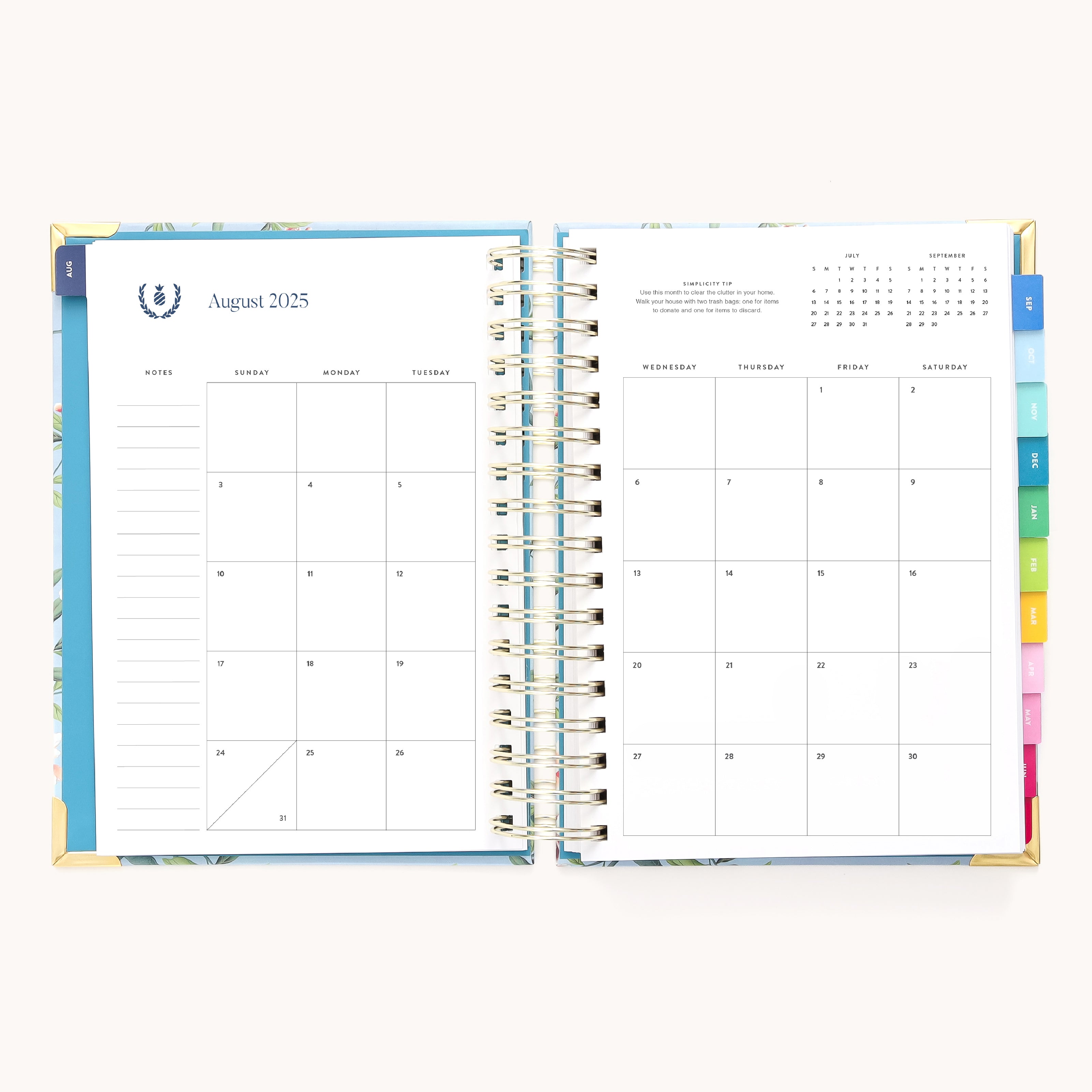 The 2025-2026 Spiral Daily Simplified Planner - Faraway Land by Simplified has an open spread with a monthly calendar for August 2025 on the left and notes on the right. Its colorful tab dividers and gold foil details add elegance, perfect for task and plan management.