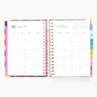 The 2025-2026 Spiral Daily Simplified Planner - Rainbow Row by Simplified opens to the August 2025 calendar, featuring note space on the left with days listed from Friday to Tuesday, and a grid on the right for Wednesday to Saturday. Gold foil details embellish its monthly tabs along the side.