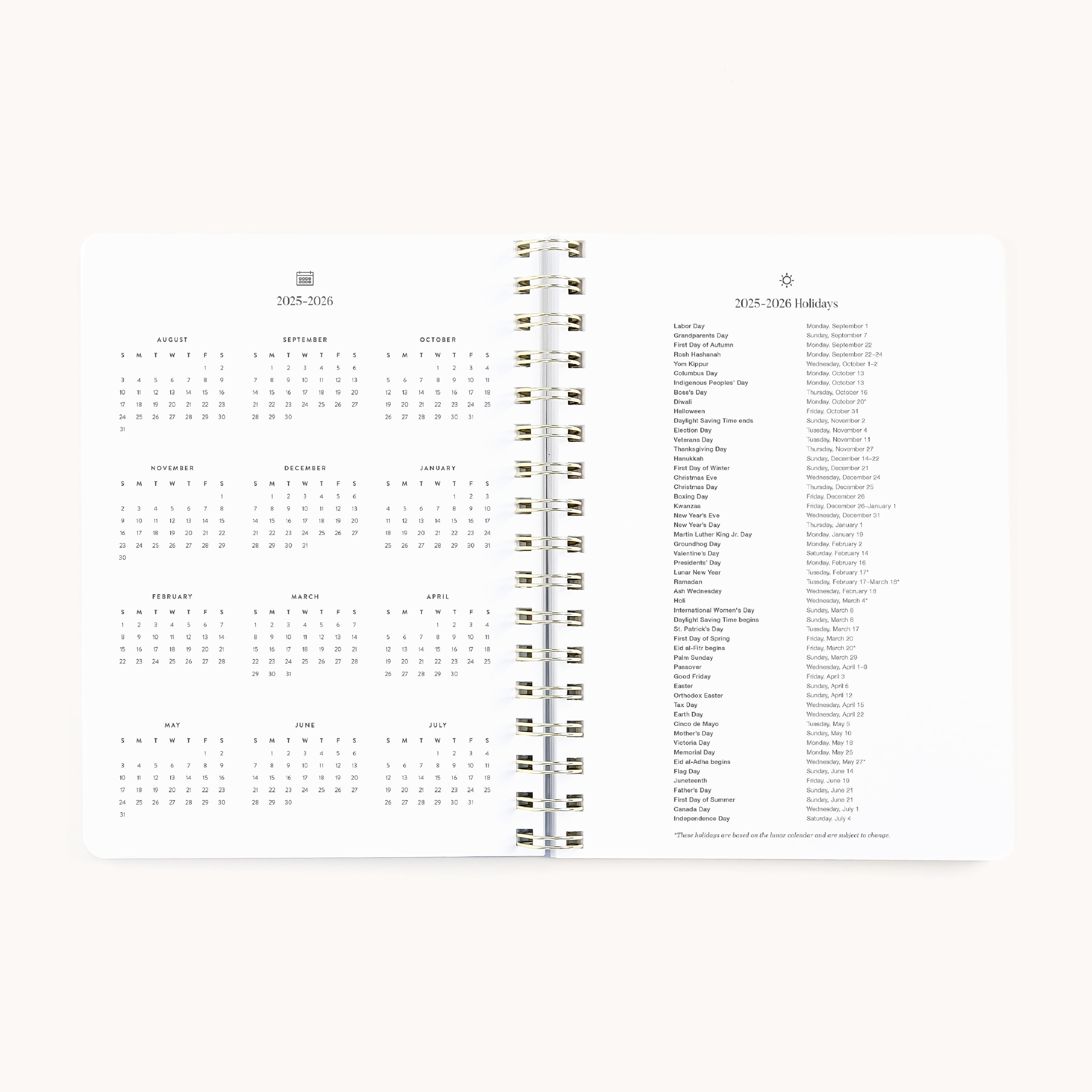 The 2025-2026 Softcover Weekly Simplified Planner - Ivory Antelope by Simplified showcases an open layout with a calendar next to a holiday list, all spiral-bound and accented in gold foil. Its clean white backdrop and dedicated Prep Work pages enhance efficient planning.