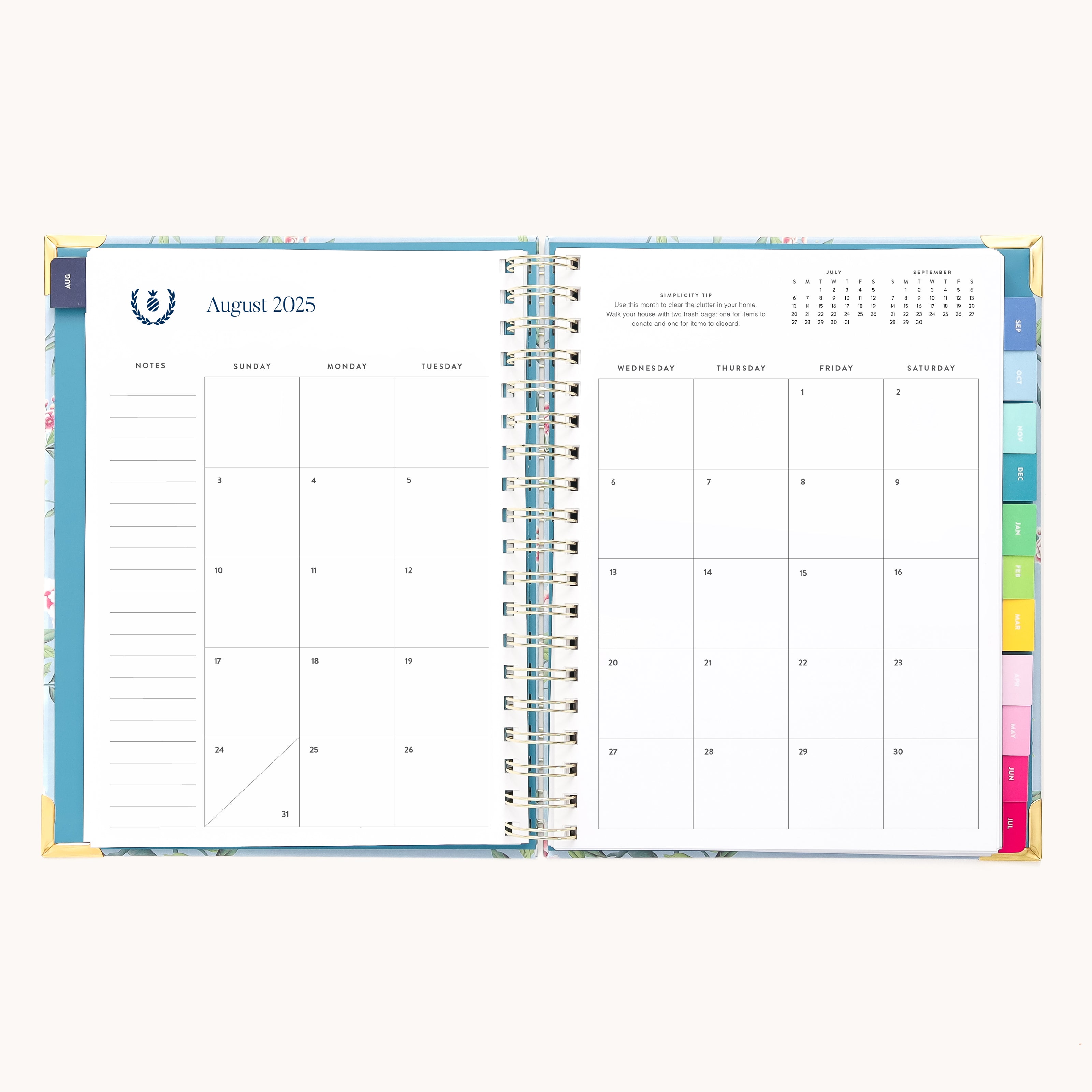 Open the Simplified 2025-2026 Spiral Weekly Planner - Faraway Land to August 2025. The left page shows Sunday-Tuesday with notes and gold foil accents; the right features Wednesday-Saturday and mini calendars for July & September, with visible side tabs.