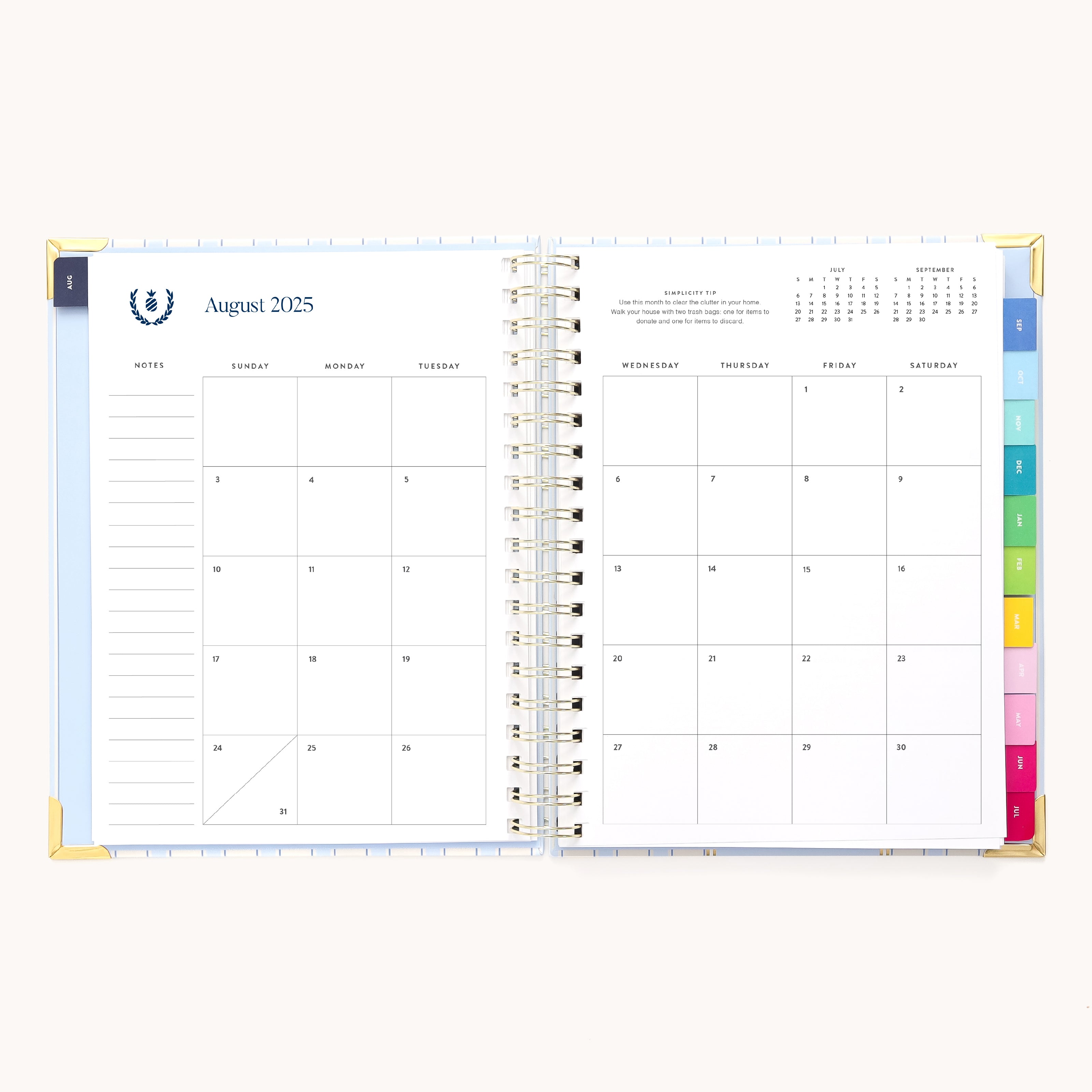 The 2025-2026 Spiral Weekly Simplified Planner by Simplified features an open monthly calendar for August 2025. Left pages have note sections and right pages display Wednesday to Saturday. It boasts gold foil details and colorful tabs for different sections, accentuating its design.