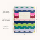 The 2026 Spiral Weekly Simplified Planner - Rainbow Row by Simplified features a colorful hardcover with wavy stripes, gold wire-o binding, gold foil details, protective gold corners, and measures 10 x 8.
